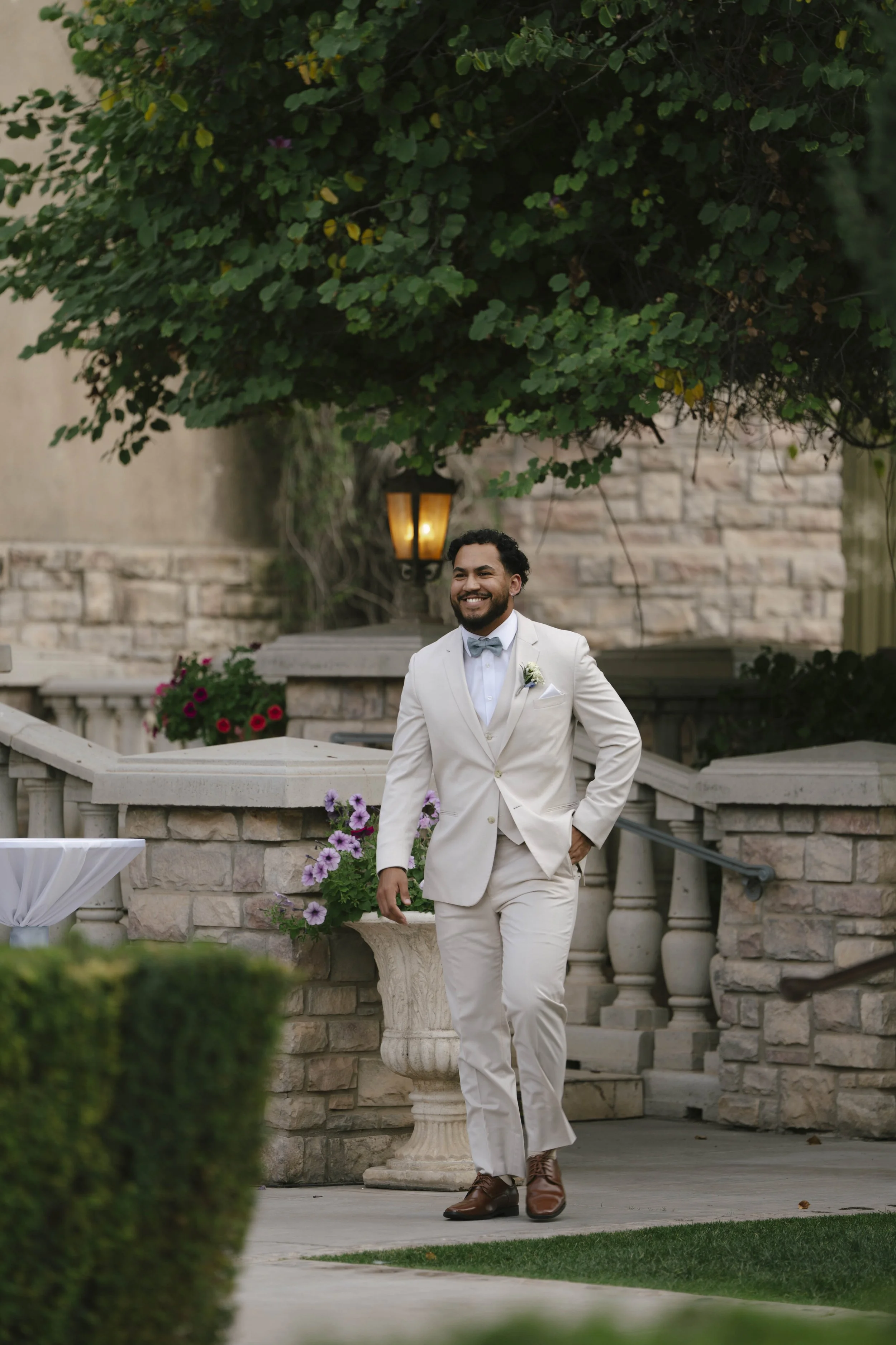 The wedding processional at Ashley Castle in Chandler, Arizona, was captured through hybrid film and digital photography, preserving the graceful entrances of the bridal party as they made their way through the romantic outdoor ceremony space surroun