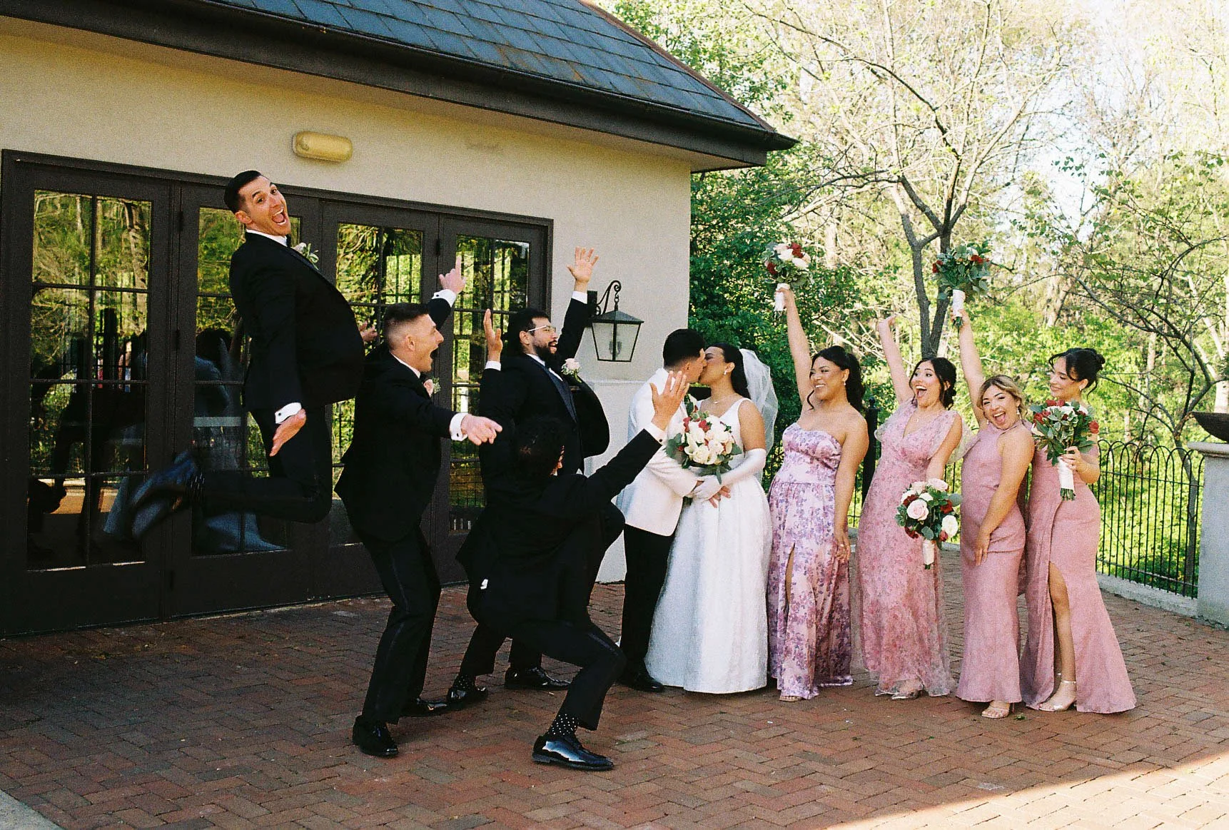 Bridal party portraits at Hotel DuVillage celebrate the bride and groom alongside their closest friends and family. Captured on digital and 35mm film, these images highlight genuine laughter, timeless portraits, and unforgettable moments.