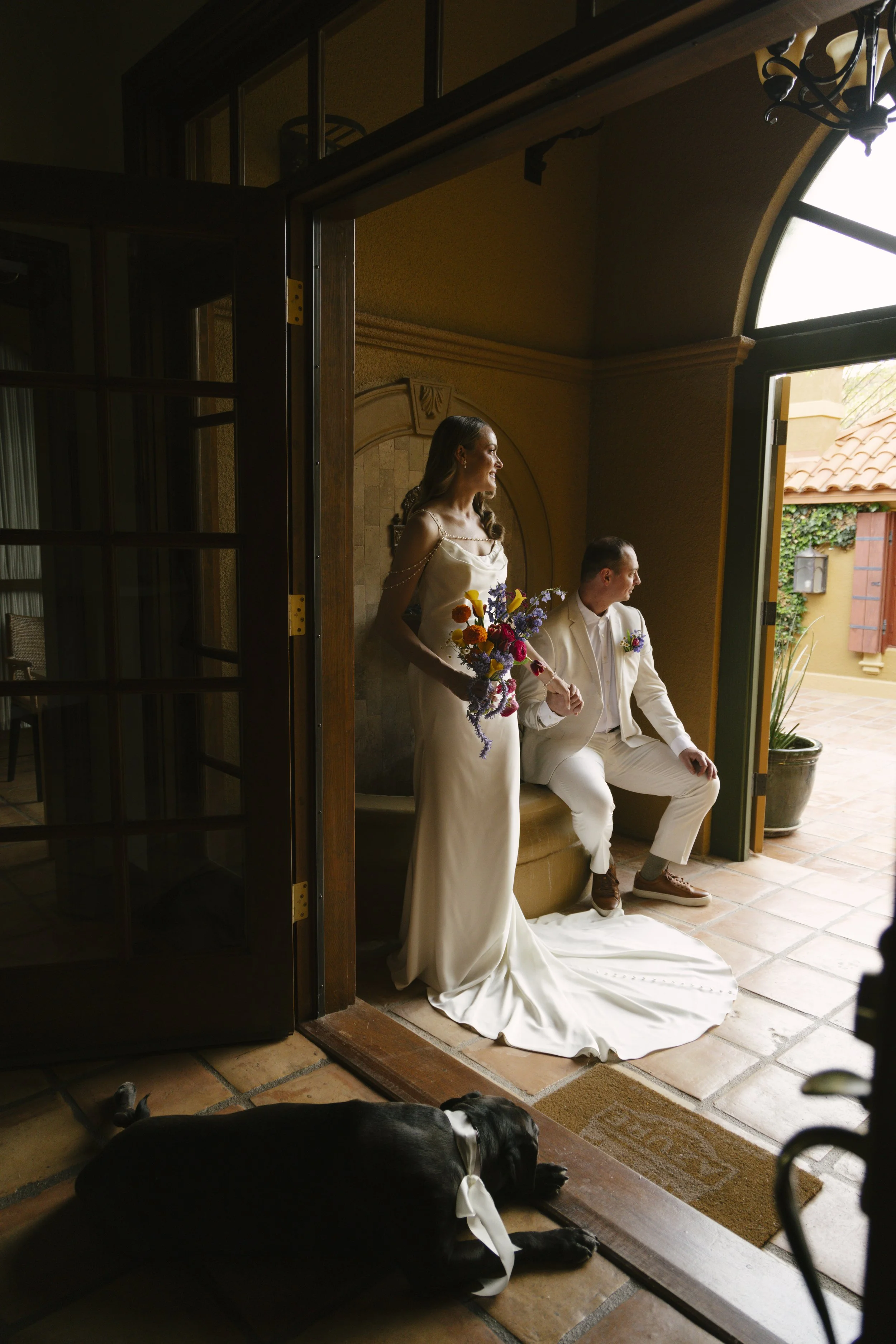 Romantic newlywed portraits from Chelsea and Travis' intimate Sedona, Arizona elopement, featuring elegant courtyard portraits, candid moments with their beloved dog, and timeless wedding photography captured after their private ceremony before golde