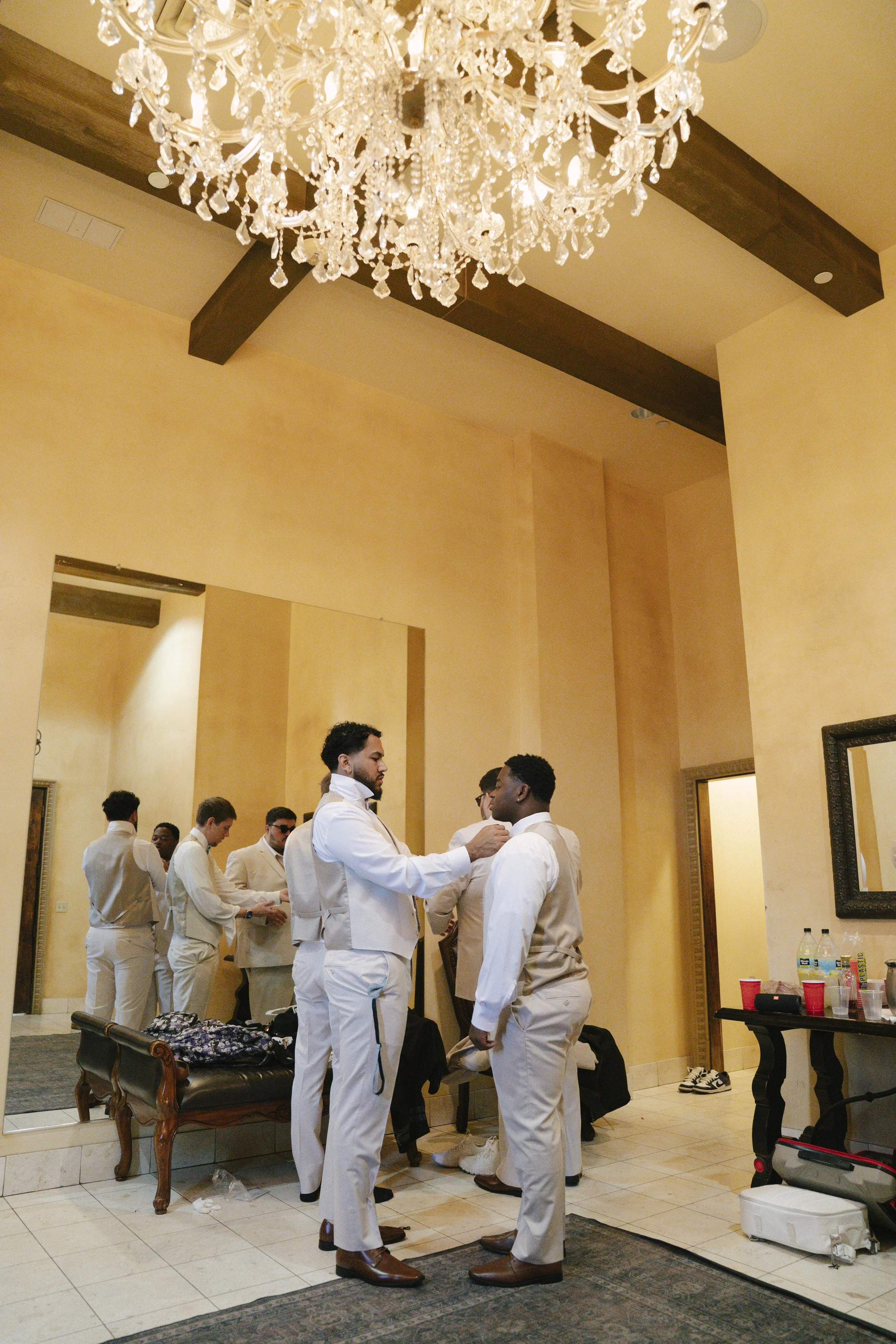 The groom’s getting-ready moments at Ashley Castle in Chandler, Arizona, capture the energy and anticipation of the wedding day, documented through hybrid film and digital photography to preserve both candid emotion and timeless detail inside this el