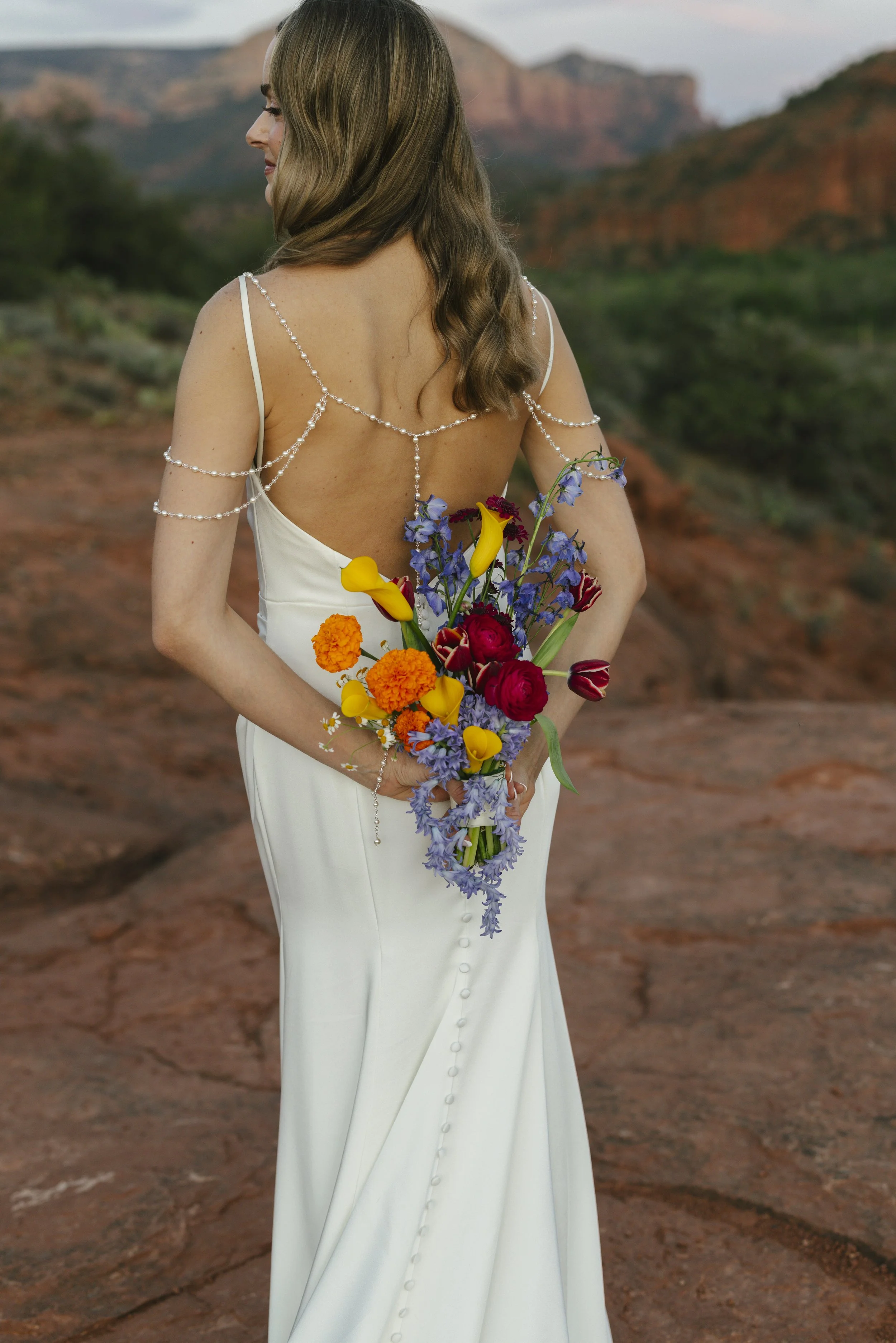 Romantic golden hour portraits at Secret Slick Rock during Chelsea and Travis' intimate Sedona elopement. Featuring Sedona's famous red rock views, stunning Arizona desert landscapes, and timeless wedding photography, these newlywed portraits perfect