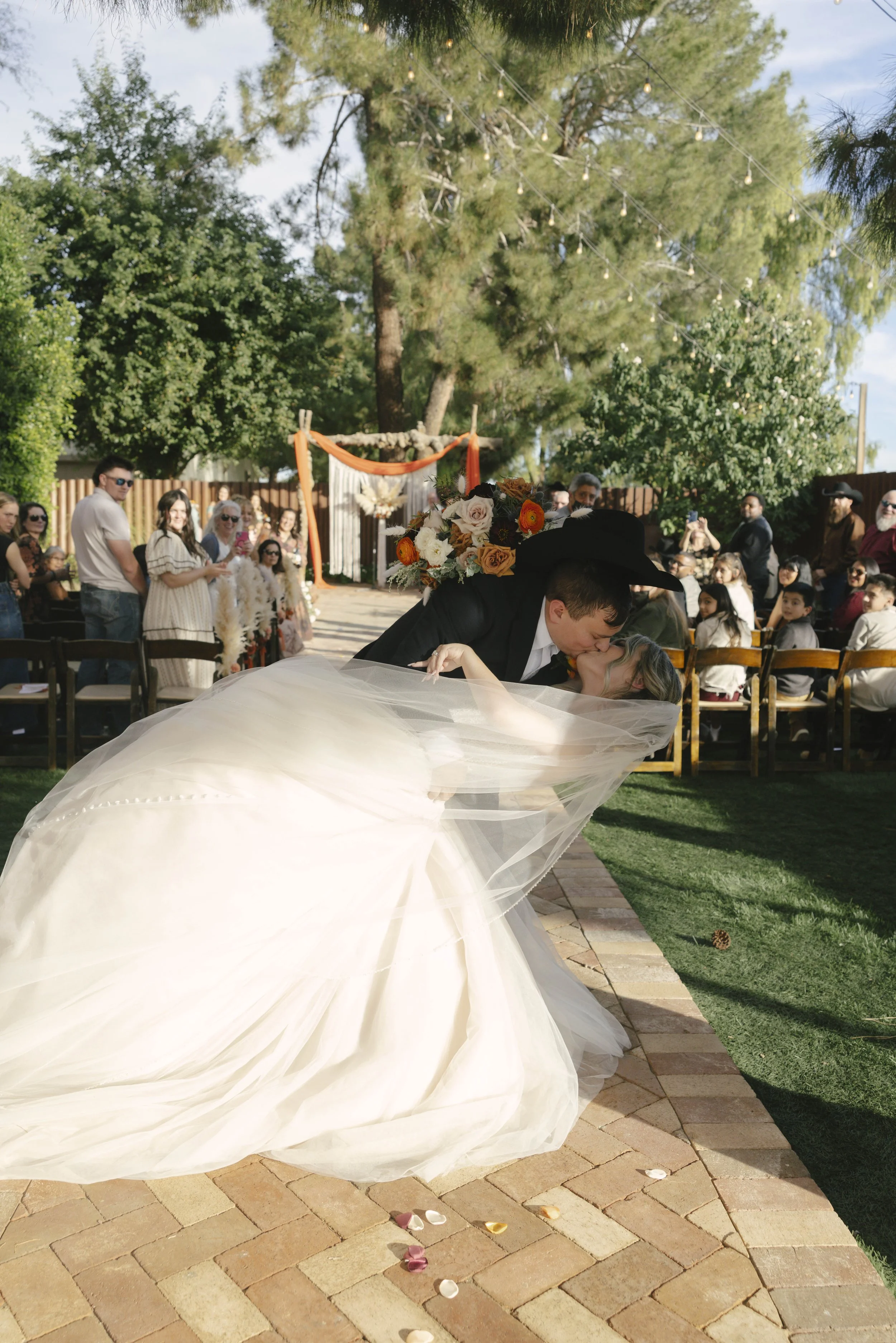 Documentary wedding photography at The Knotty Barn in Queen Creek, Arizona, captured by Arizona wedding photographer Raw By Laura, showcasing authentic moments, desert scenery, and a rustic western wedding setting.