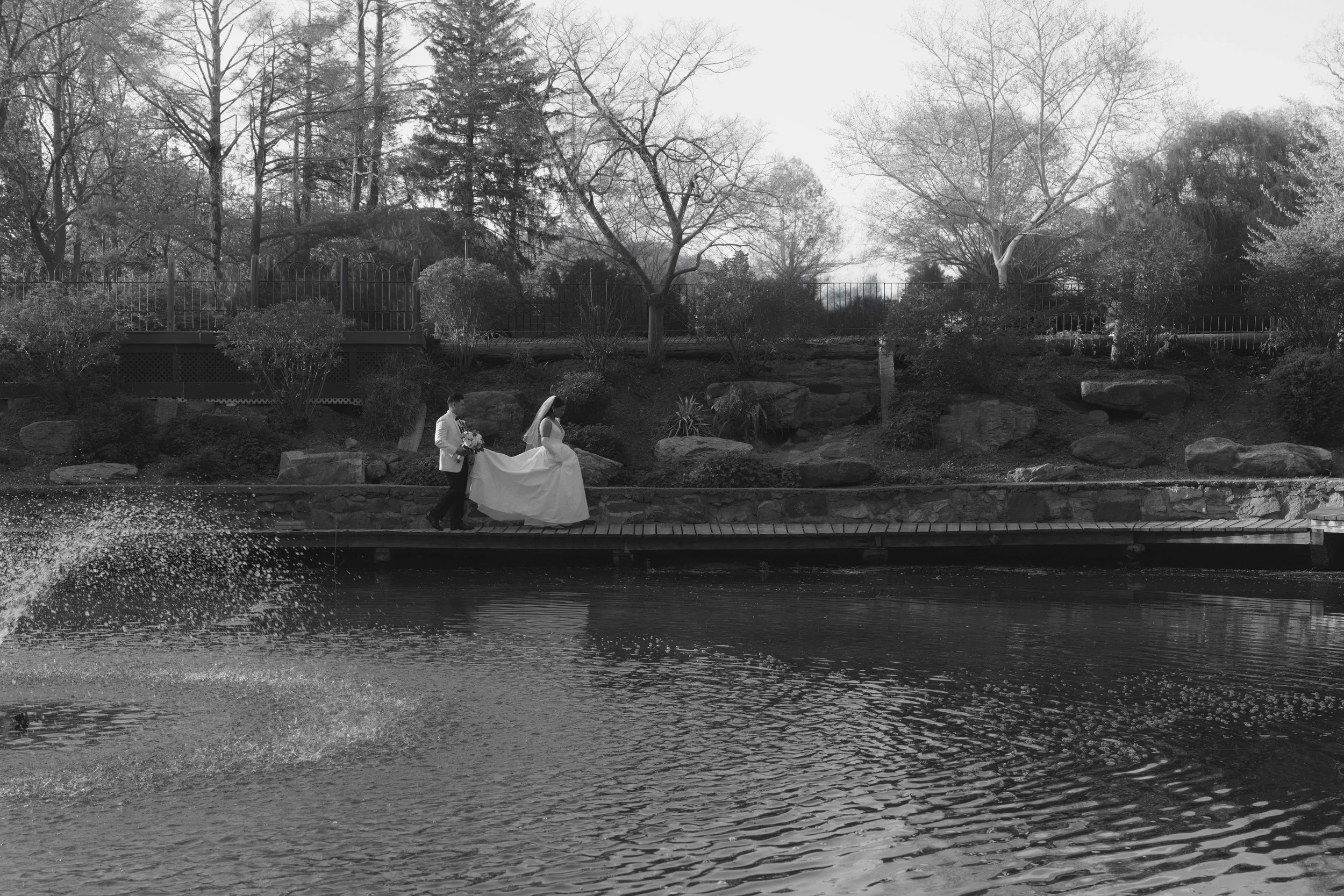 Bride and groom portraits at Hotel DuVillage showcase the venue's picturesque gardens, waterfront views, and timeless charm. Photographed on both digital and 35mm film, these wedding portraits focus on authentic connection, natural movement, and cand