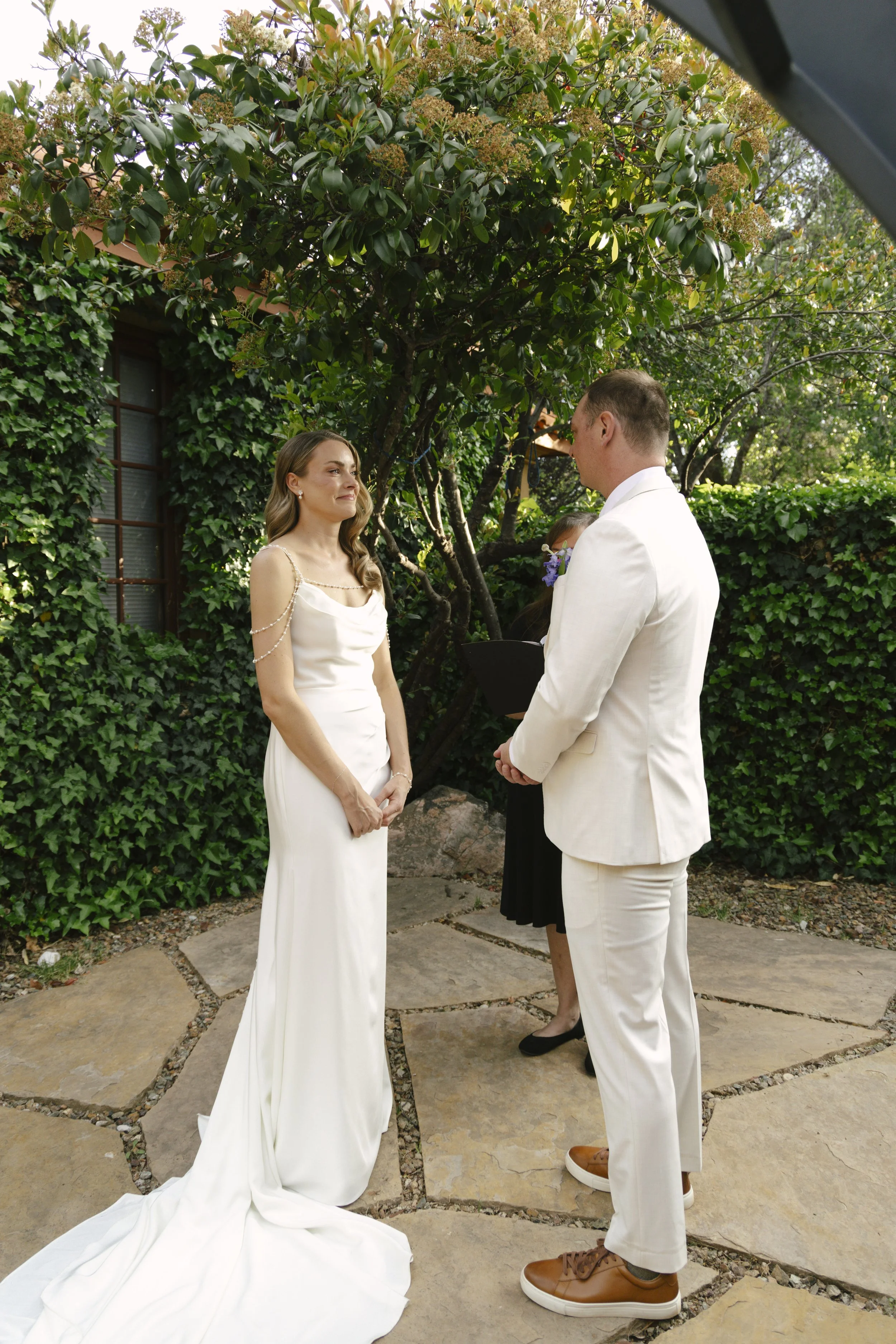 Chelsea and Travis exchanged heartfelt vows during their intimate Sedona elopement at a private Arizona home, surrounded by their closest family, friends, and beloved dog. Their outdoor ceremony was filled with meaningful moments, personal vows, and 