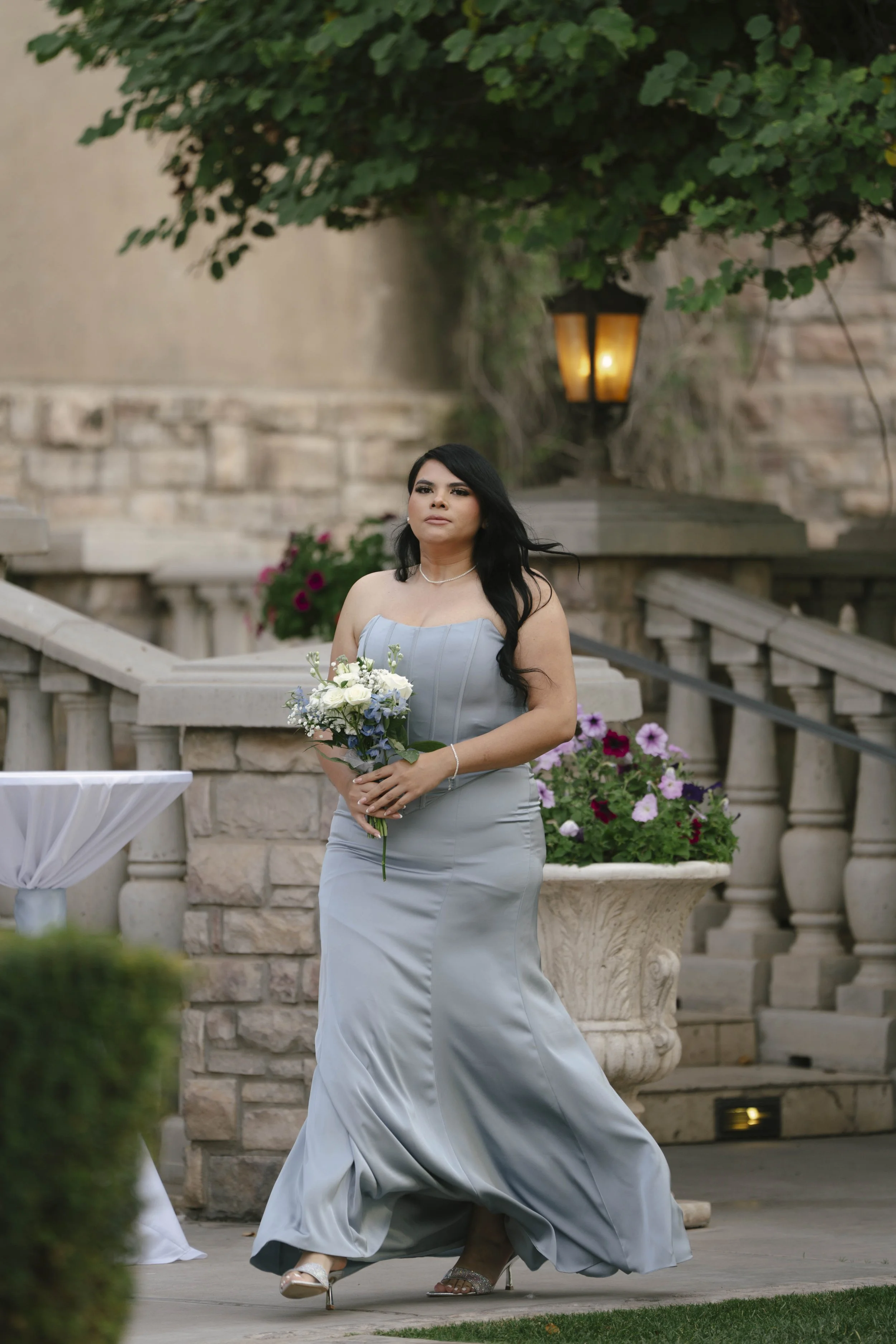 The wedding processional at Ashley Castle in Chandler, Arizona, was captured through hybrid film and digital photography, preserving the graceful entrances of the bridal party as they made their way through the romantic outdoor ceremony space surroun