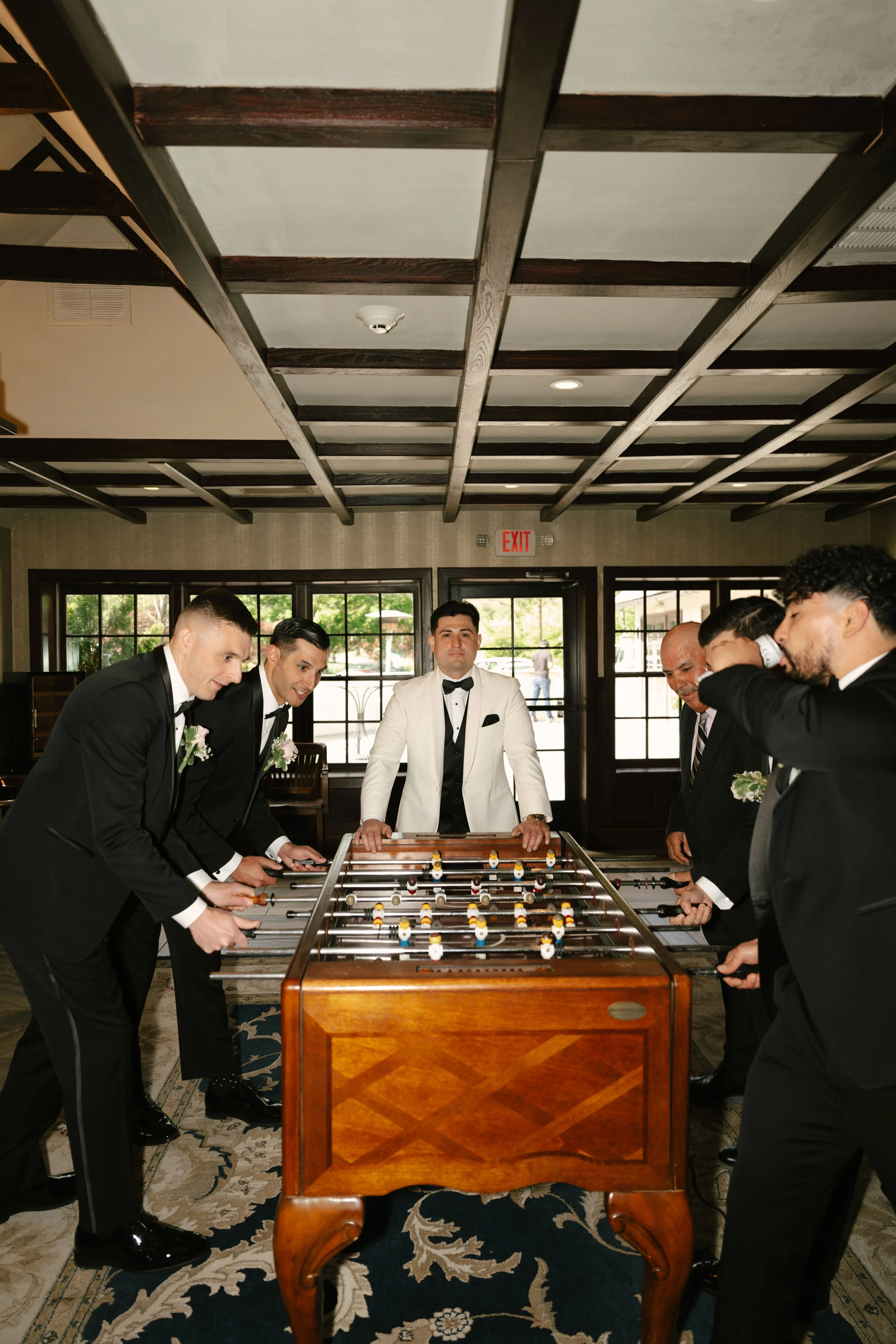 Groom getting ready at Hotel DuVillage before Andy & Elmer's May 2026 wedding. Captured by Raw By Laura using a blend of digital and 35mm film photography, documenting genuine moments with family and friends.