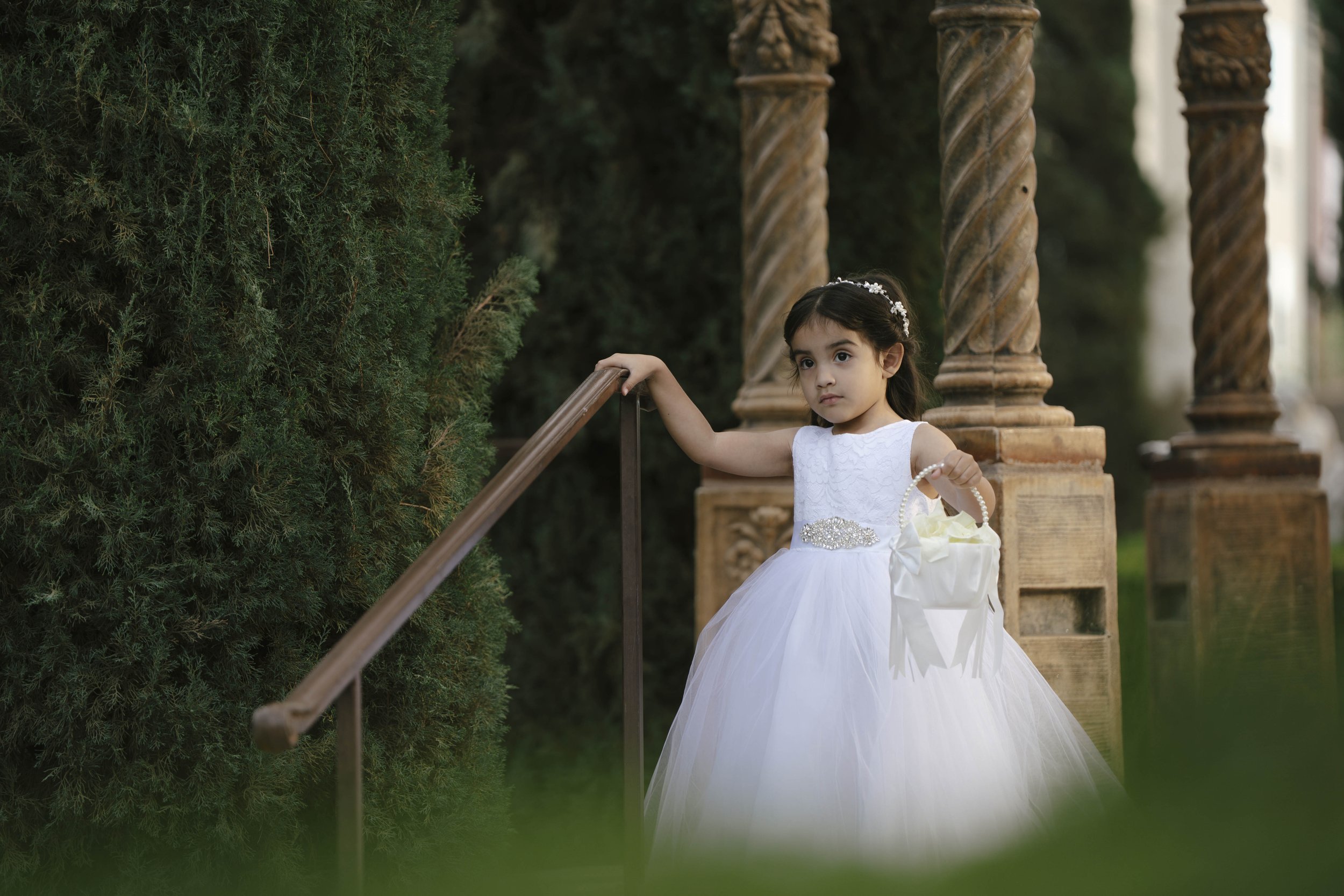 The wedding processional at Ashley Castle in Chandler, Arizona, was captured through hybrid film and digital photography, preserving the graceful entrances of the bridal party as they made their way through the romantic outdoor ceremony space surroun