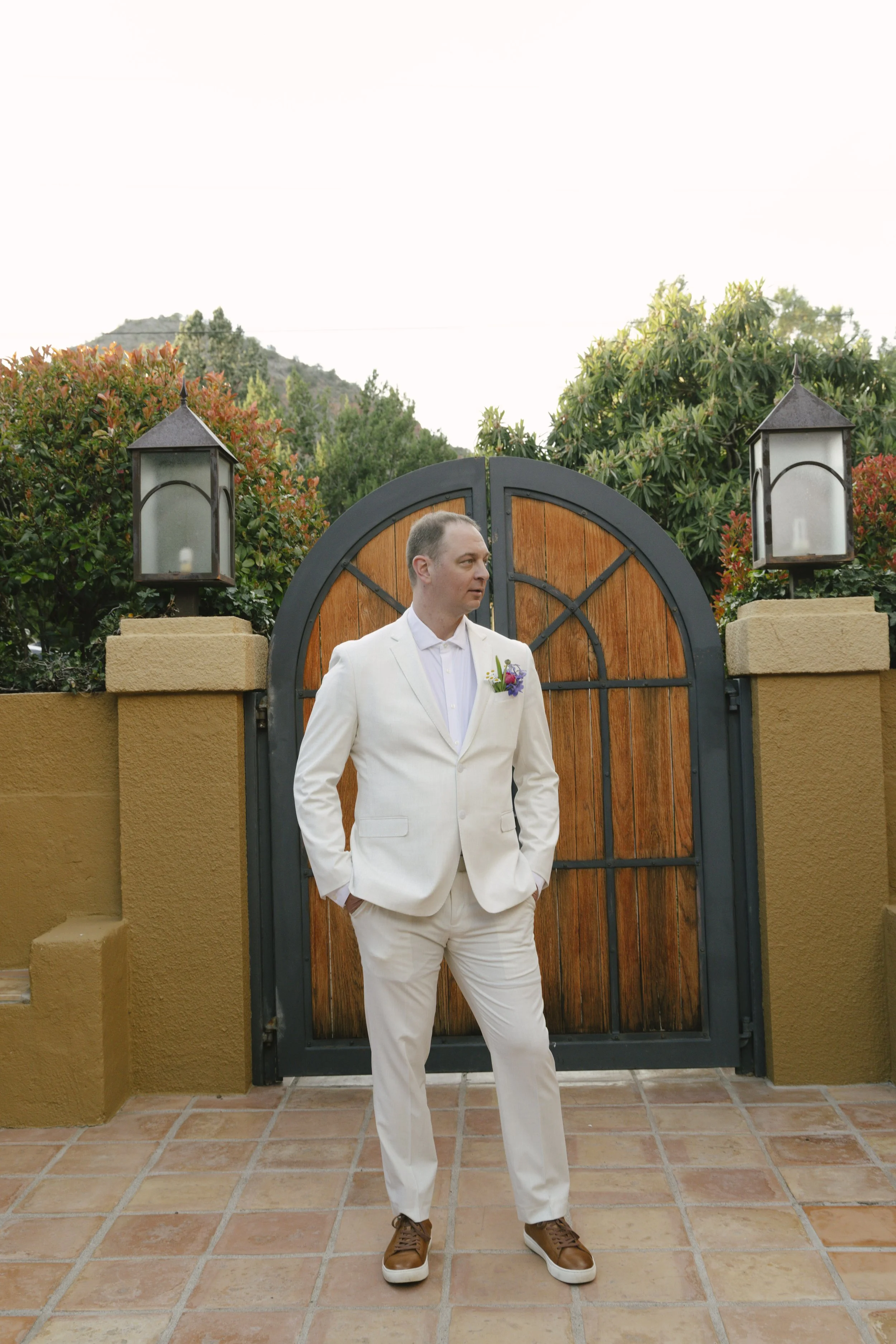 Romantic newlywed portraits from Chelsea and Travis' intimate Sedona, Arizona elopement, featuring elegant courtyard portraits, candid moments with their beloved dog, and timeless wedding photography captured after their private ceremony before golde