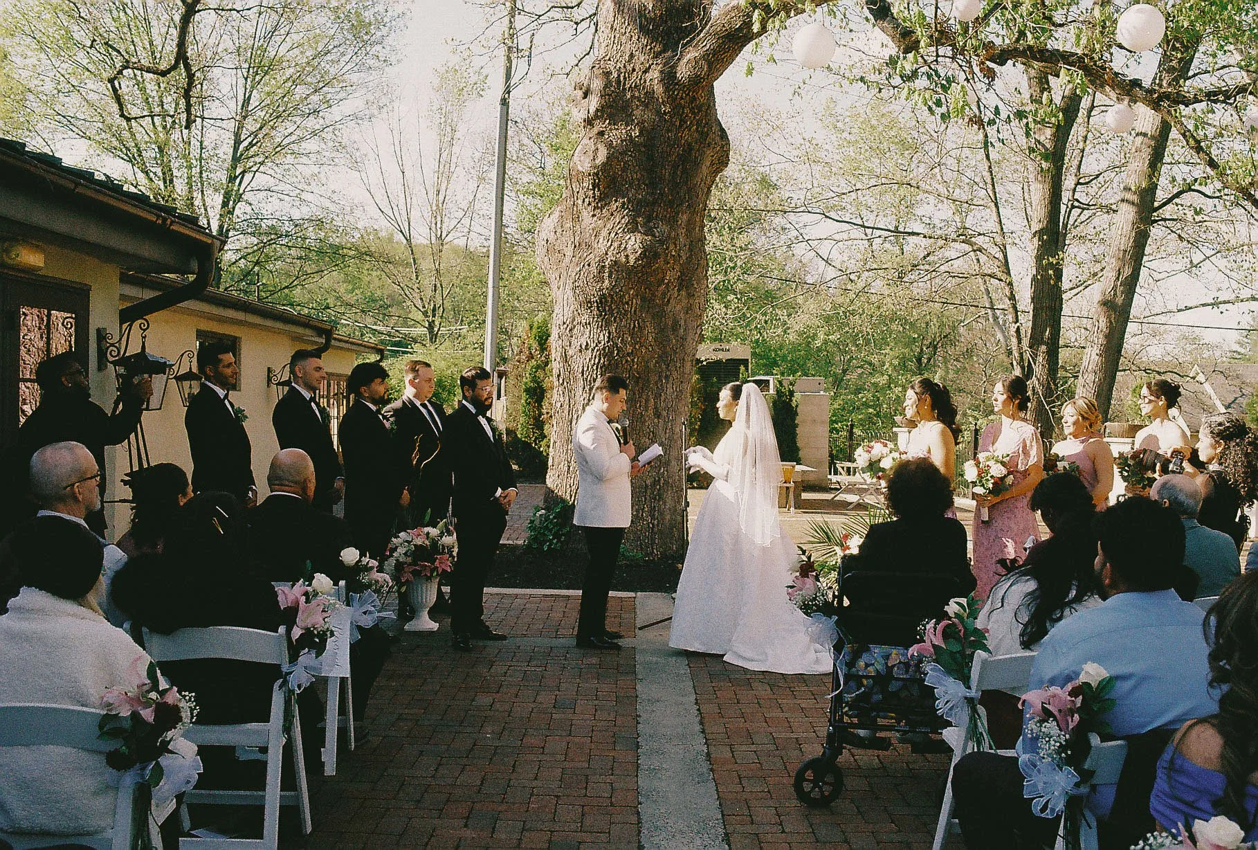 Outdoor wedding ceremony at Hotel DuVillage featuring the bride and groom, wedding party, and meaningful moments captured on both digital and 35mm film. A timeless celebration documented with a candid, documentary approach