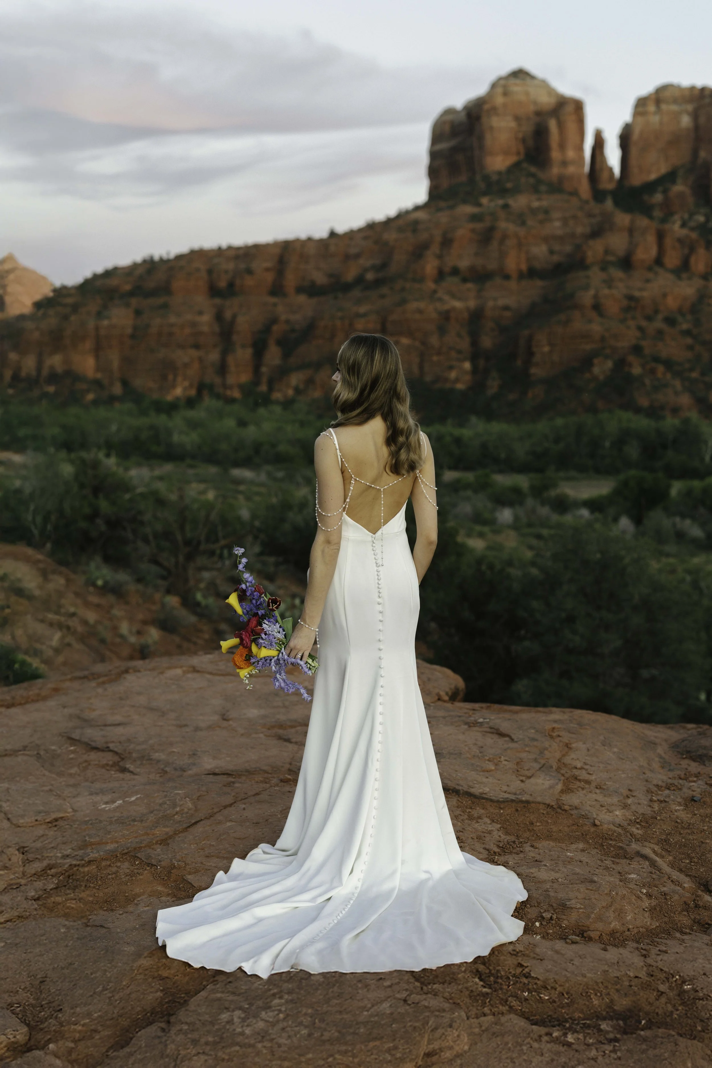 Romantic golden hour portraits at Secret Slick Rock during Chelsea and Travis' intimate Sedona elopement. Featuring Sedona's famous red rock views, stunning Arizona desert landscapes, and timeless wedding photography, these newlywed portraits perfect