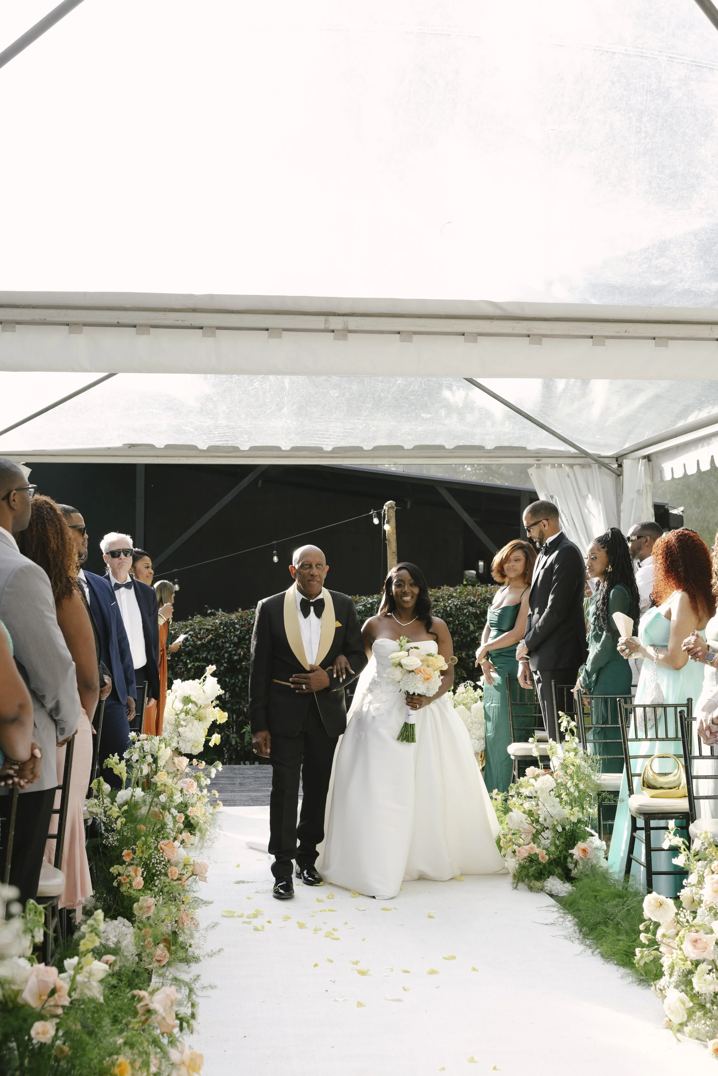 Forest Campestre wedding ceremony in Medellín, Colombia featuring the bridal processional, groom's reaction, emotional ceremony moments, floral aisle design, wedding guests, and documentary-style wedding photography