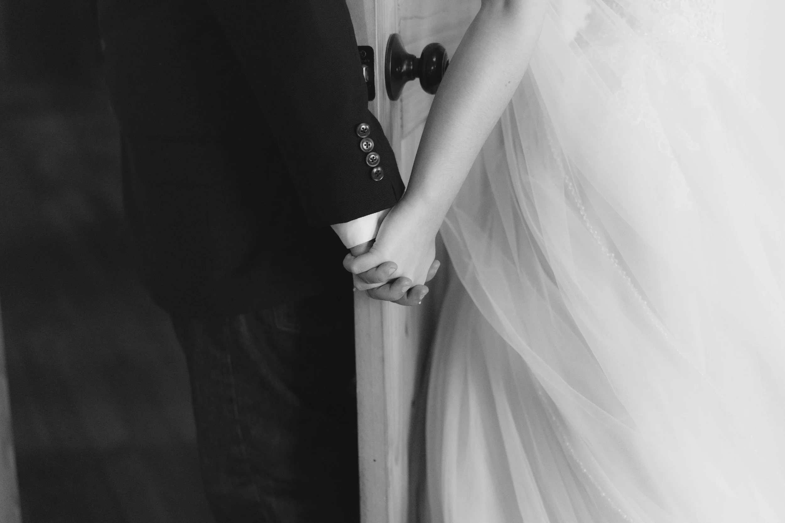 Intimate first touch moment at The Knotty Barn wedding in Queen Creek, Arizona, where the couple shared a private prayer and laughter before the ceremony, captured with candid, documentary-style storytelling by Arizona wedding photographer Raw By Lau