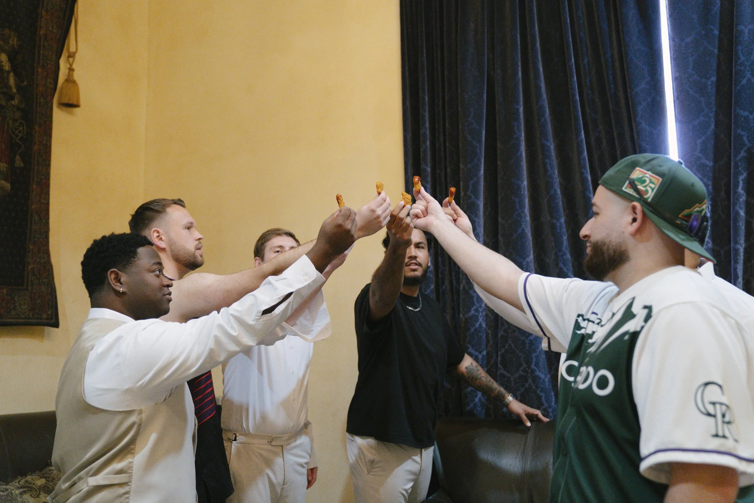 The groom’s getting-ready moments at Ashley Castle in Chandler, Arizona, capture the energy and anticipation of the wedding day, documented through hybrid film and digital photography to preserve both candid emotion and timeless detail inside this el