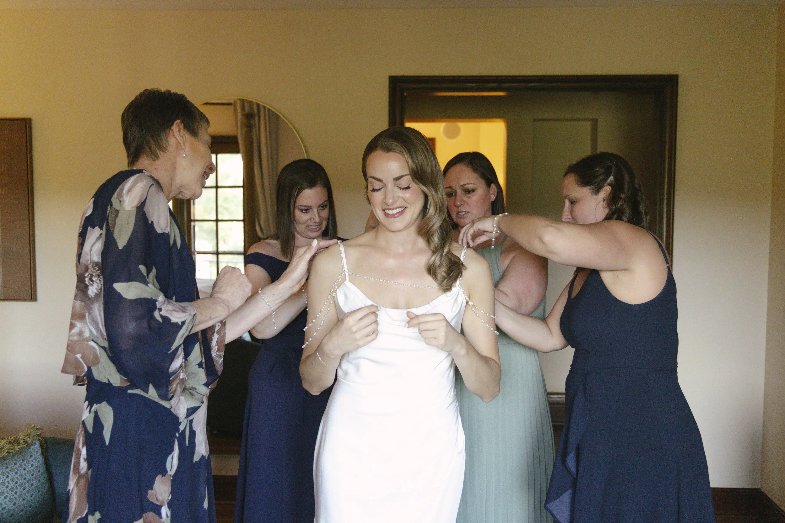 Chelsea and Travis' intimate Sedona elopement continued with heartfelt bridal getting-ready moments as the bride shared meaningful time with her mother and closest loved ones. From fastening her wedding dress and adding the finishing touches to quiet