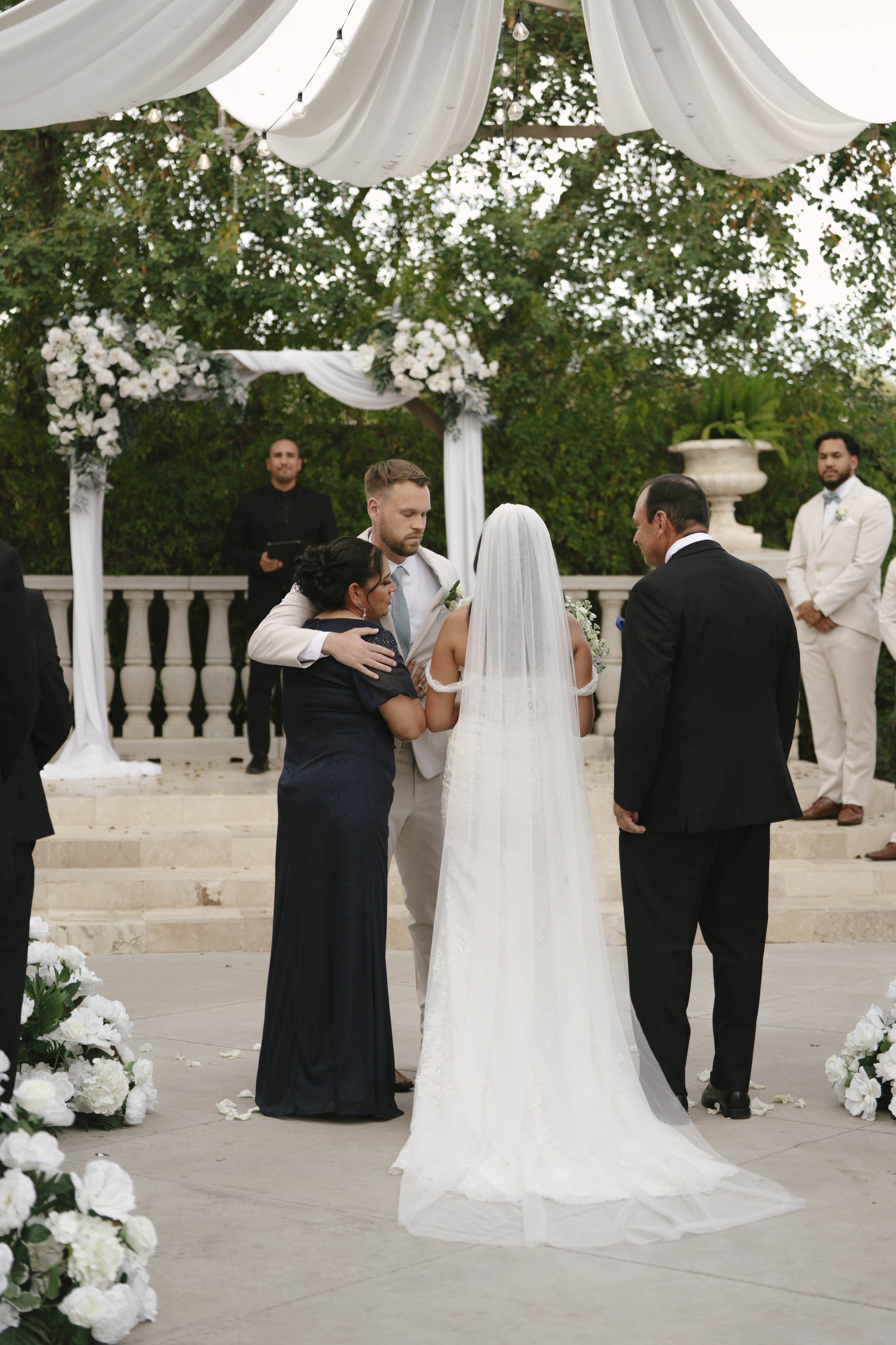 The wedding processional at Ashley Castle in Chandler, Arizona, was captured through hybrid film and digital photography, preserving the graceful entrances of the bridal party as they made their way through the romantic outdoor ceremony space surroun