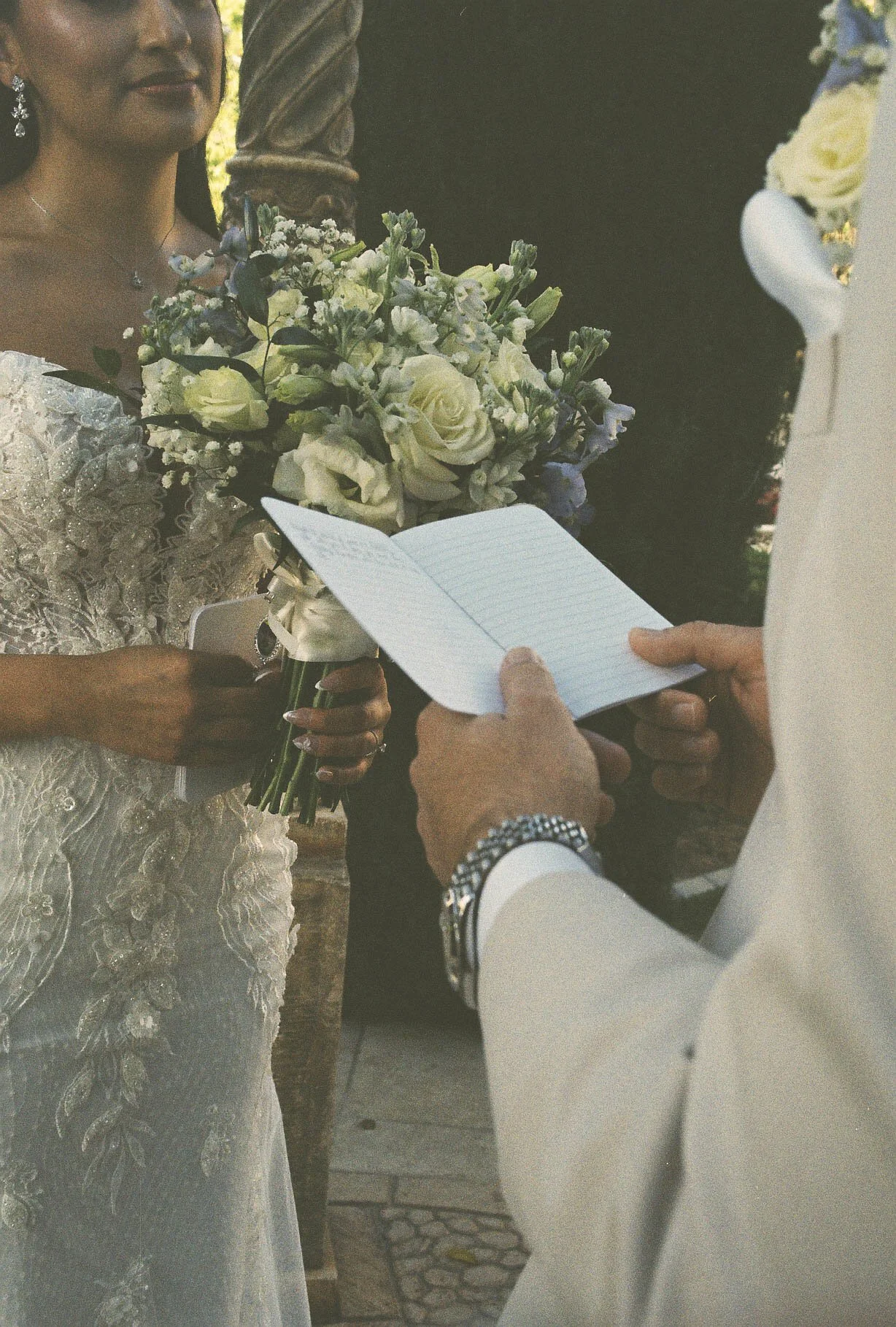 The bride and groom’s first look at Ashley Castle in Chandler, Arizona, unfolded in the venue’s romantic garden gazebo, where hybrid film and digital photography captured their emotional private reveal with timeless elegance, natural light, and intim