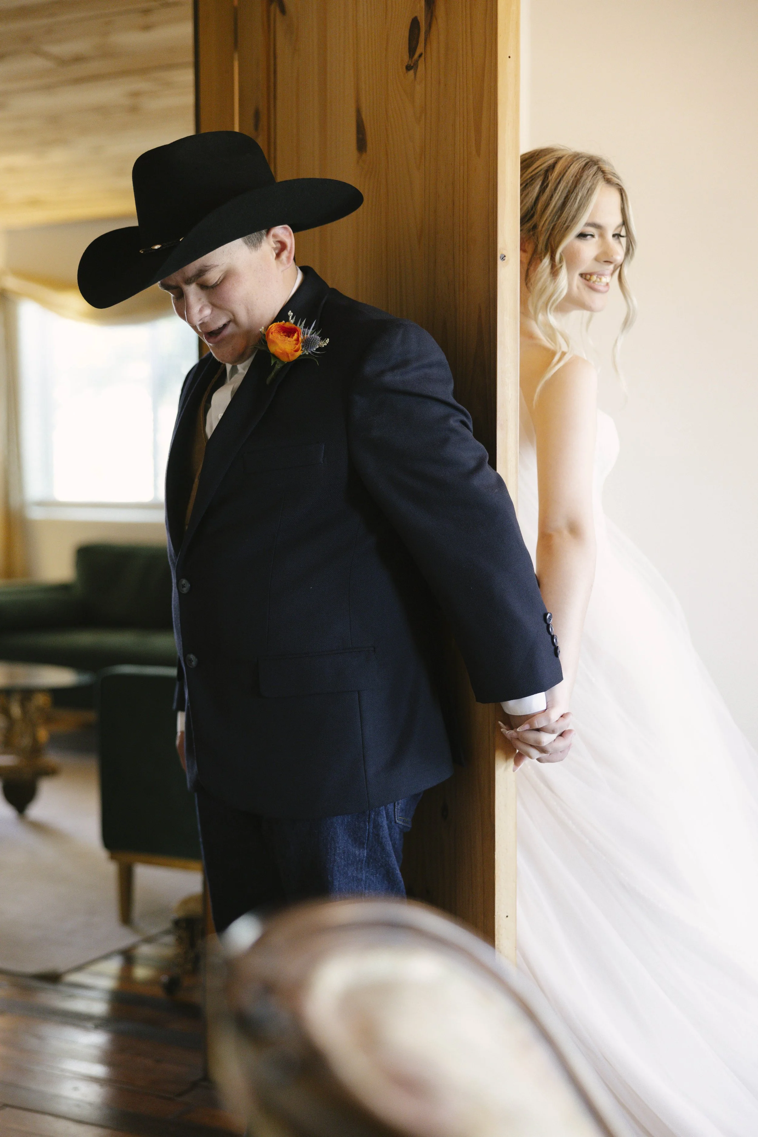 Intimate first touch moment at The Knotty Barn wedding in Queen Creek, Arizona, where the couple shared a private prayer and laughter before the ceremony, captured with candid, documentary-style storytelling by Arizona wedding photographer Raw By Lau