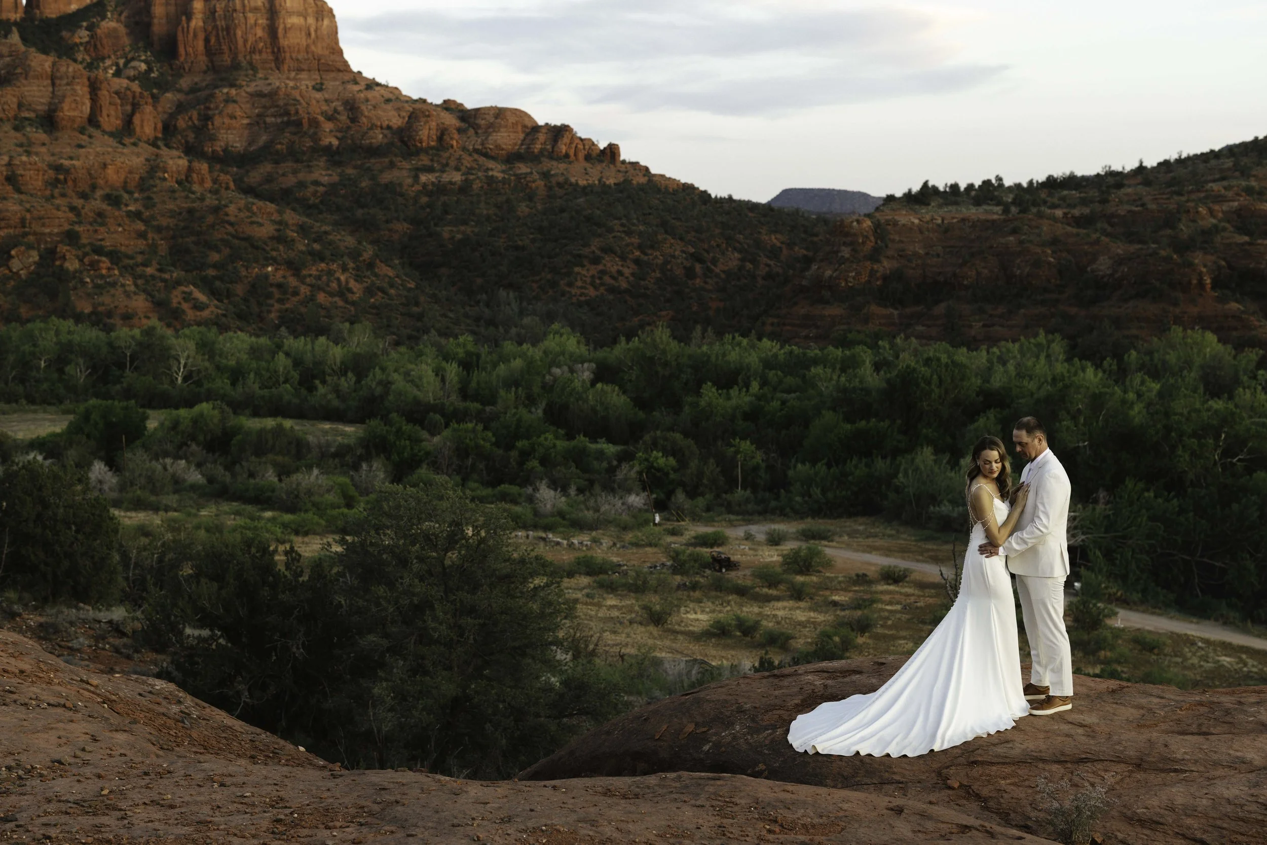 Romantic golden hour portraits at Secret Slick Rock during Chelsea and Travis' intimate Sedona elopement. Featuring Sedona's famous red rock views, stunning Arizona desert landscapes, and timeless wedding photography, these newlywed portraits perfect
