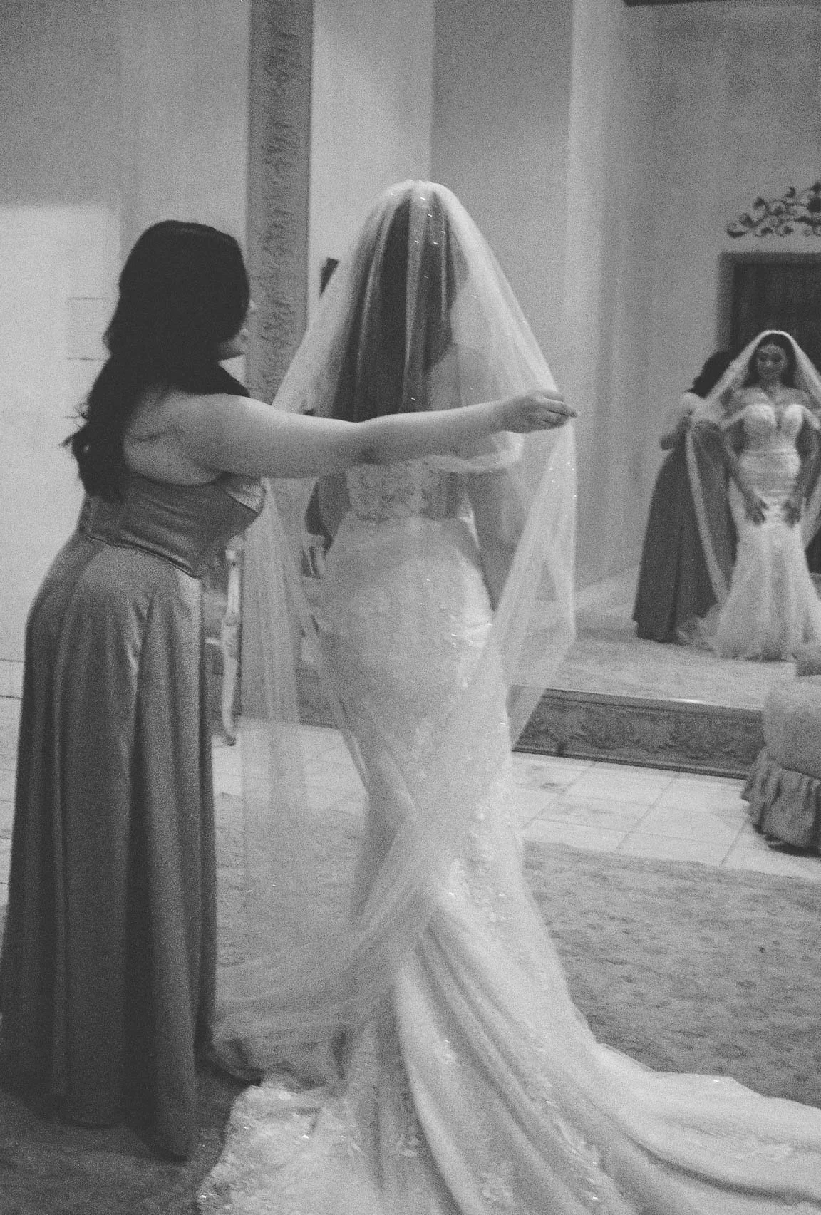 The bride’s final getting-ready moments at Ashley Castle in Chandler, Arizona, were captured through hybrid film and digital photography, preserving the intimate details of dress fastening, veil placement, and bridal finishing touches with timeless e