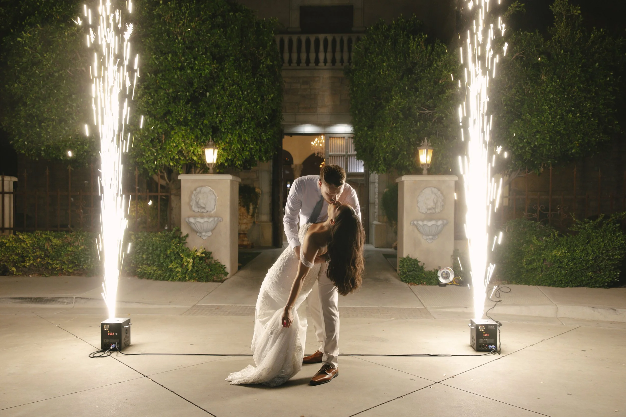 The bride and groom ended their Ashley Castle wedding in Chandler, Arizona, with a romantic nighttime portrait surrounded by sparkling cold sparklers, captured through hybrid film and digital photography for a cinematic and unforgettable wedding fina