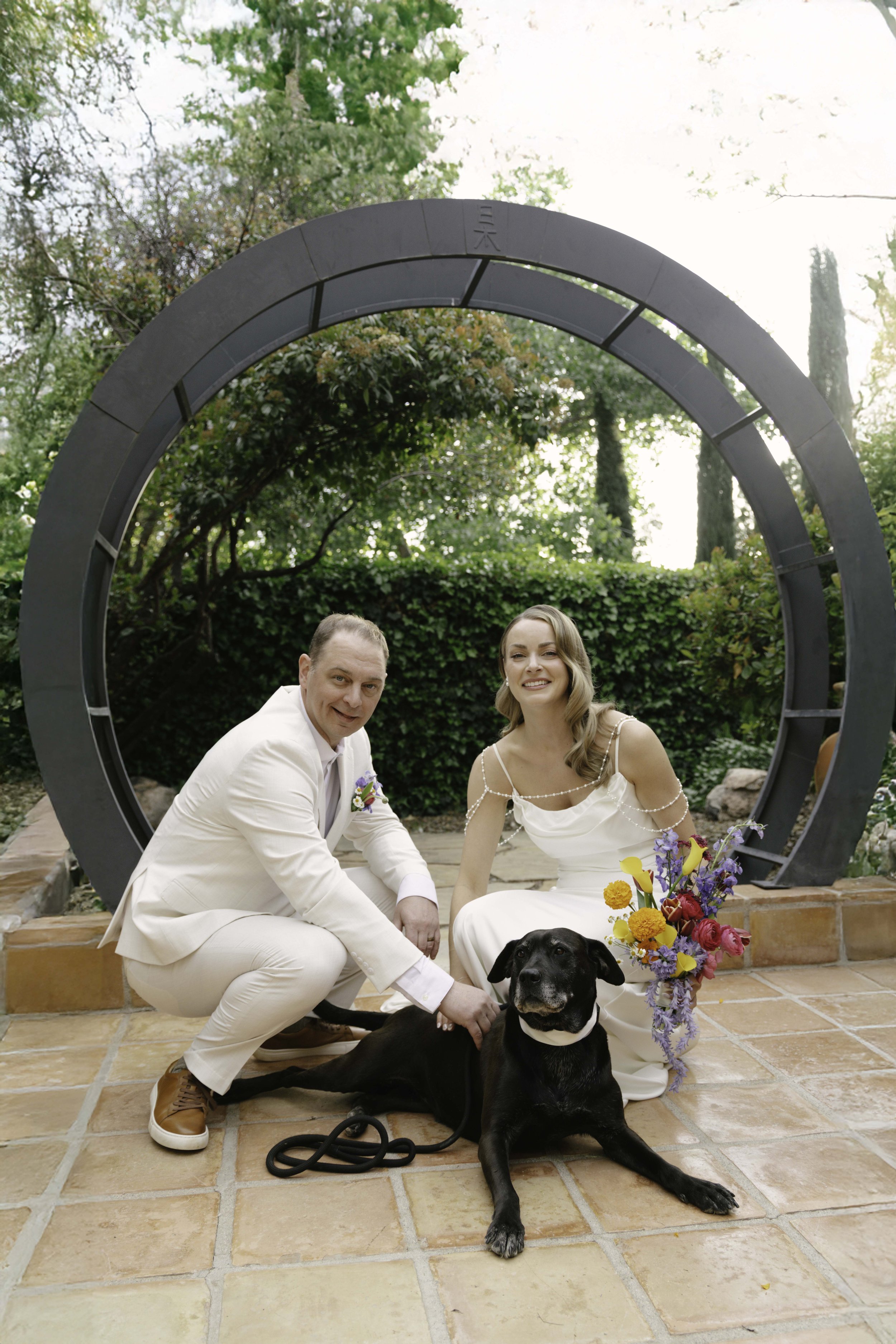 Romantic newlywed portraits from Chelsea and Travis' intimate Sedona, Arizona elopement, featuring elegant courtyard portraits, candid moments with their beloved dog, and timeless wedding photography captured after their private ceremony before golde