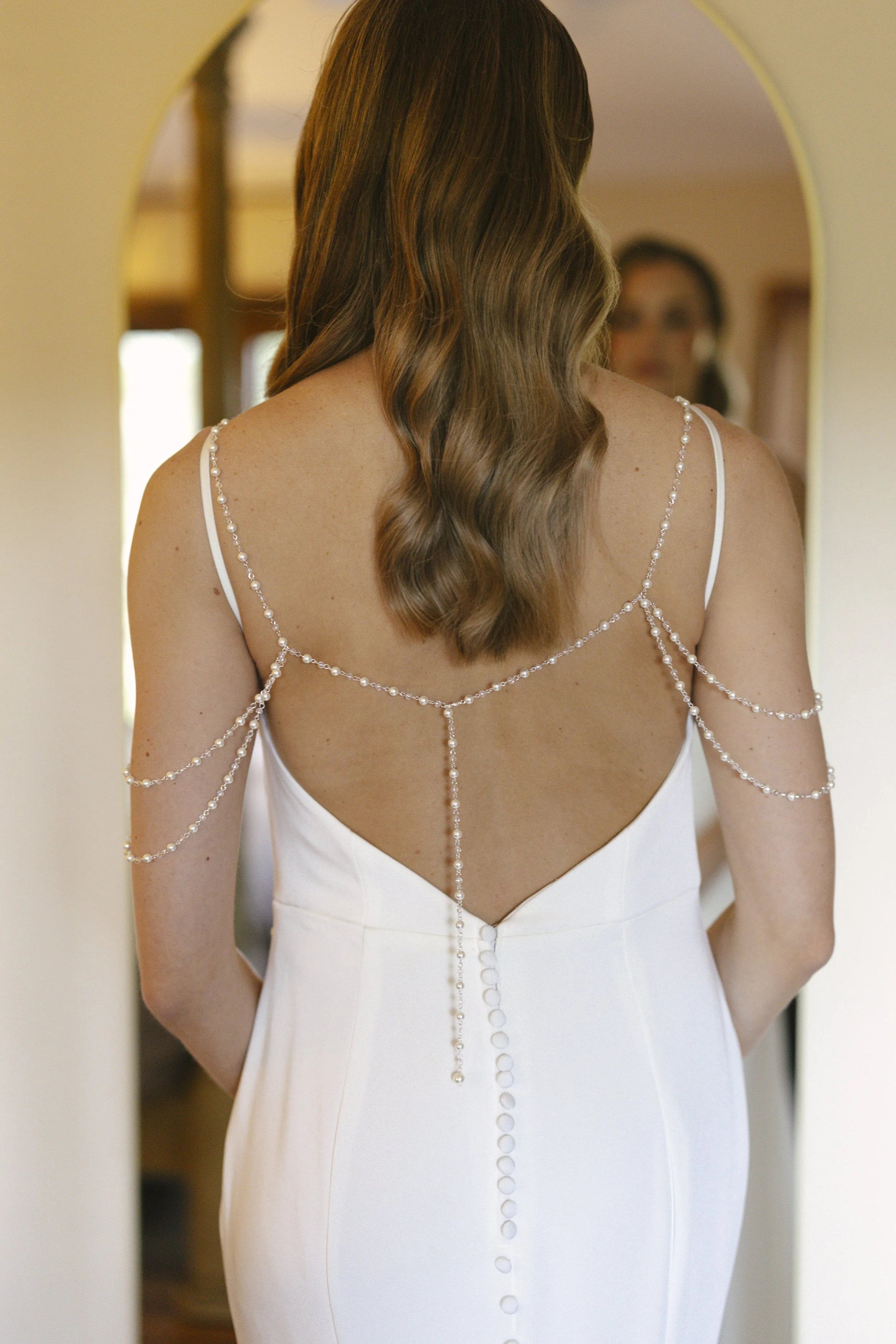 Chelsea and Travis' intimate Sedona elopement continued with heartfelt bridal getting-ready moments as the bride shared meaningful time with her mother and closest loved ones. From fastening her wedding dress and adding the finishing touches to quiet