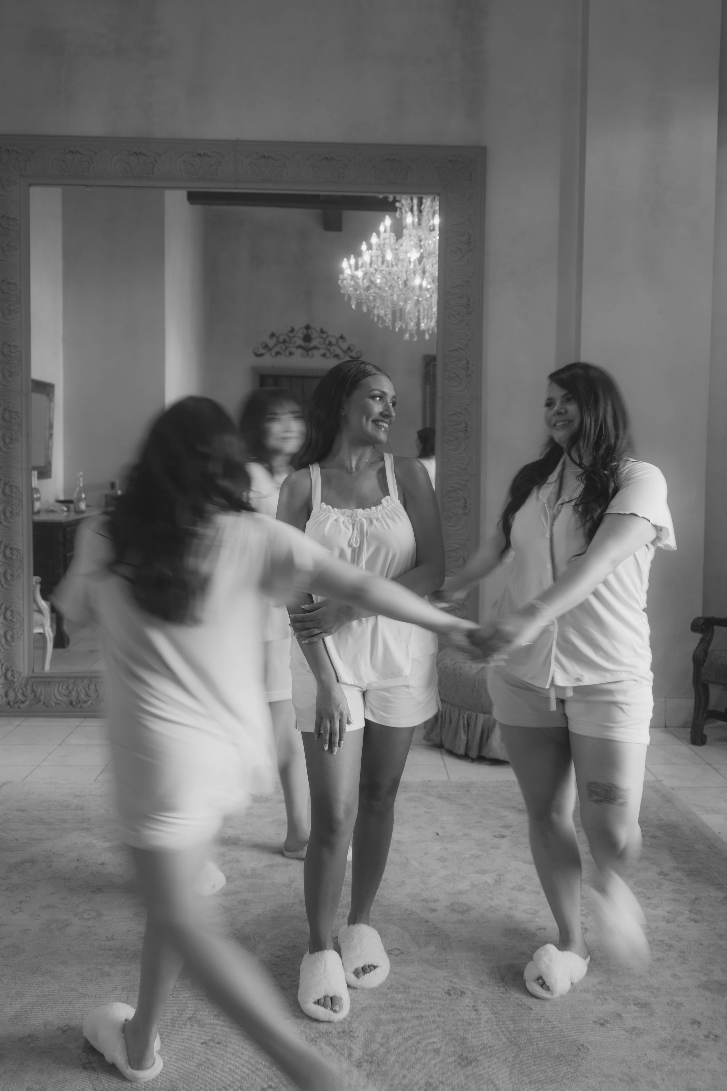 The bride shared joyful getting-ready moments with her bridal party inside Ashley Castle in Chandler, Arizona, where laughter, champagne toasts, and final floral touches were captured through hybrid film and digital photography for a timeless and hea