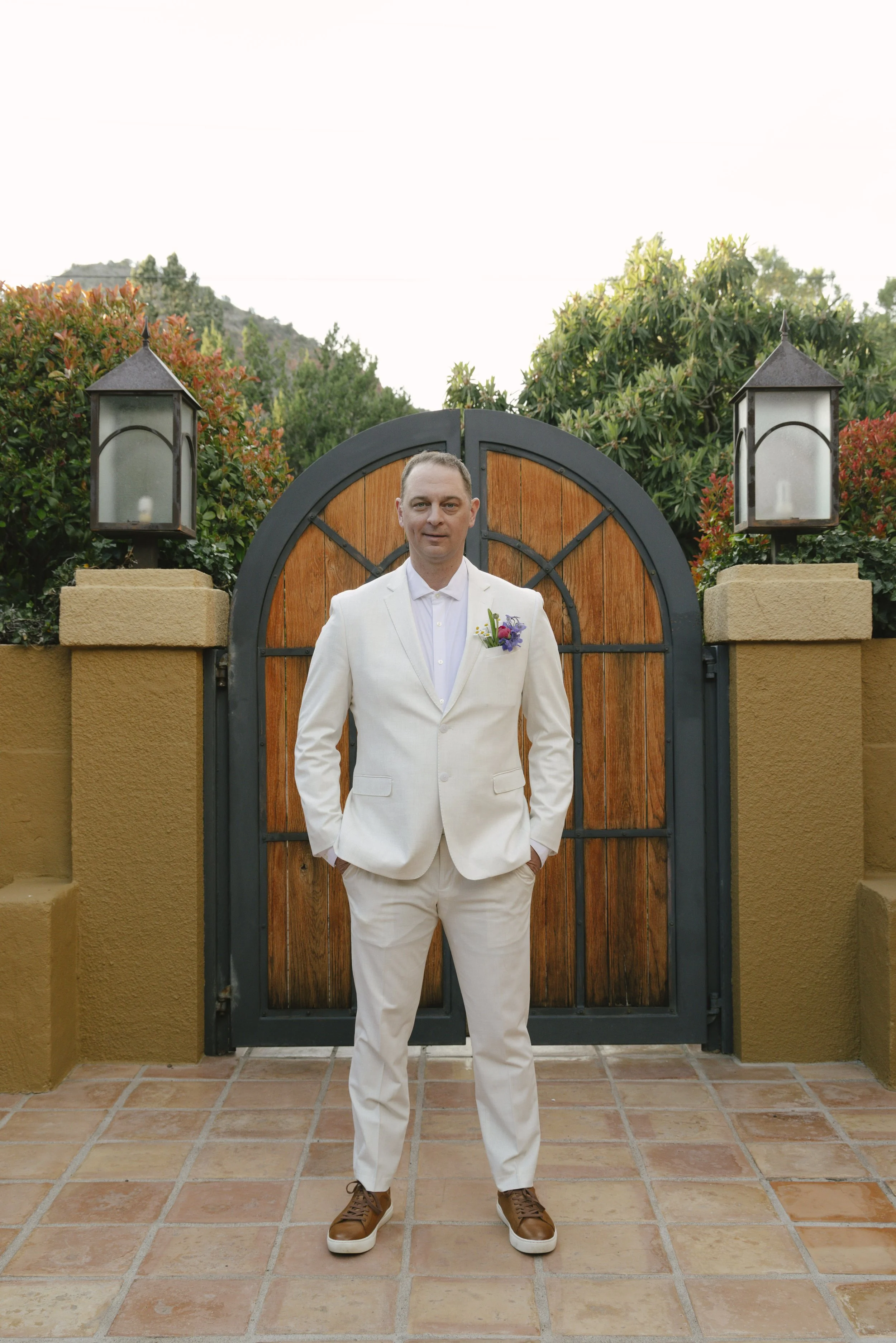 Romantic newlywed portraits from Chelsea and Travis' intimate Sedona, Arizona elopement, featuring elegant courtyard portraits, candid moments with their beloved dog, and timeless wedding photography captured after their private ceremony before golde