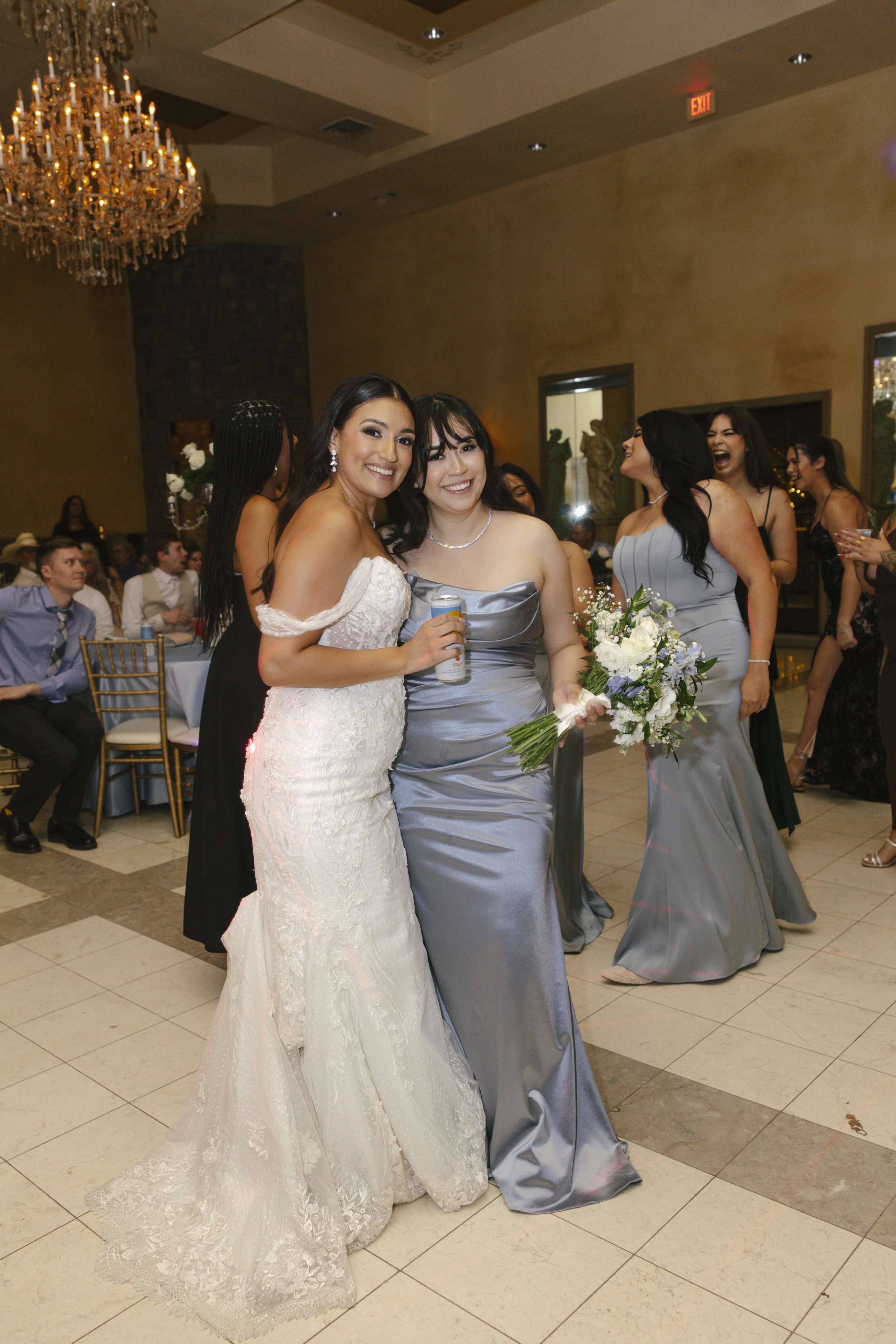 The reception celebration at Ashley Castle in Chandler, Arizona, came to life through hybrid film and digital photography, capturing elegant reception details, joyful bridal party entrances, and lively dance floor moments inside the castle’s grand ba