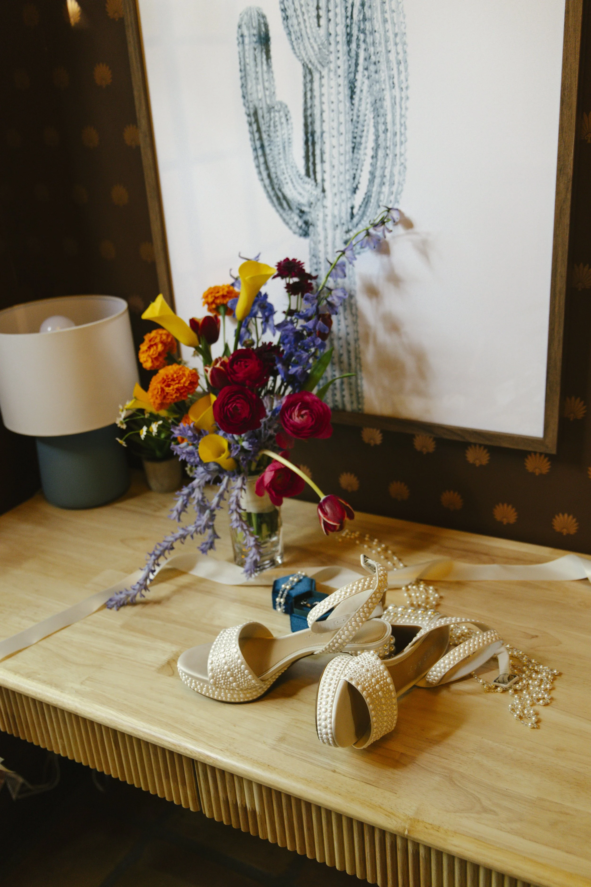Elegant bridal details from Chelsea and Travis' intimate Sedona elopement, featuring the bride's wedding dress, shoes, rings, jewelry, and vibrant bouquet before getting ready for their private Arizona ceremony. Every carefully chosen detail reflecte