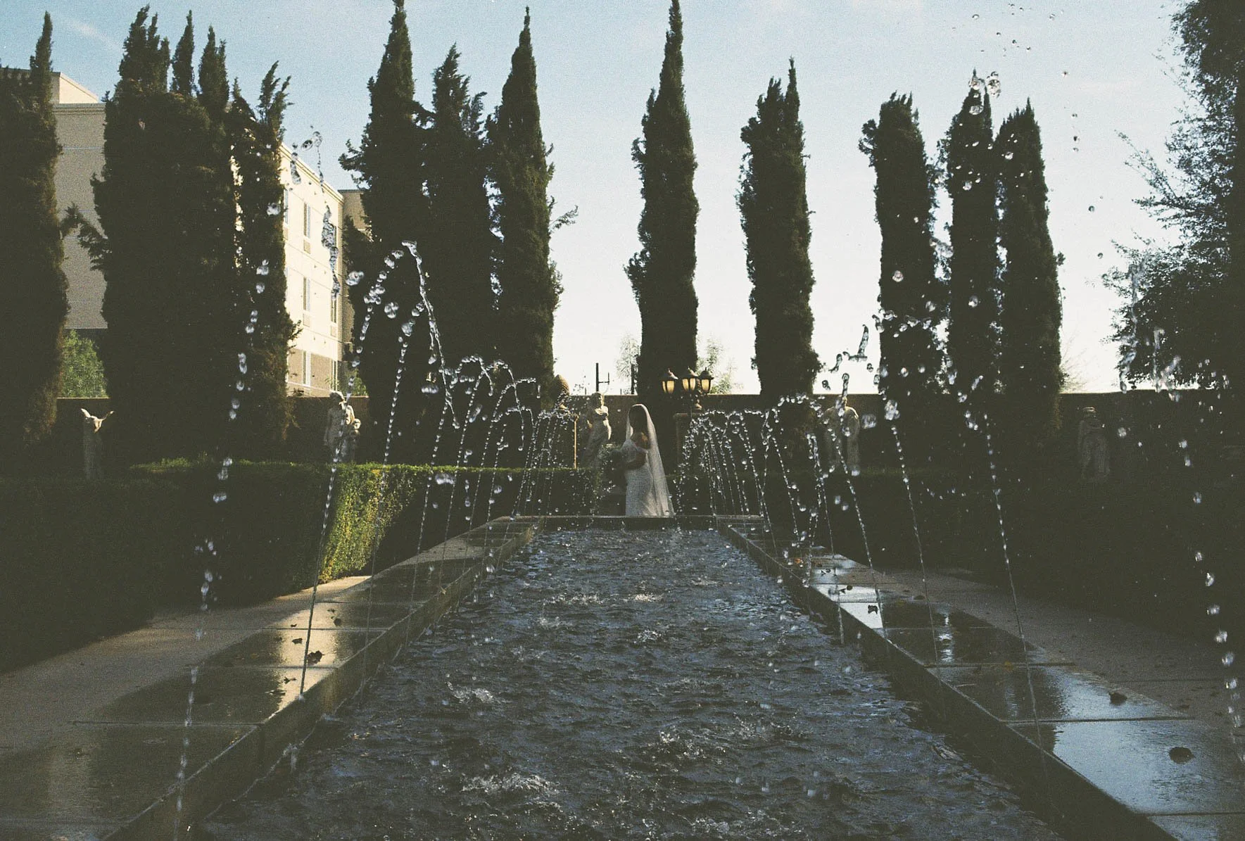 Romantic bride and groom portraits at Ashley Castle in Chandler, Arizona, captured through hybrid film and digital photography, showcase intimate newlywed moments filled with emotion, elegant garden backdrops, and timeless wedding-day connection.