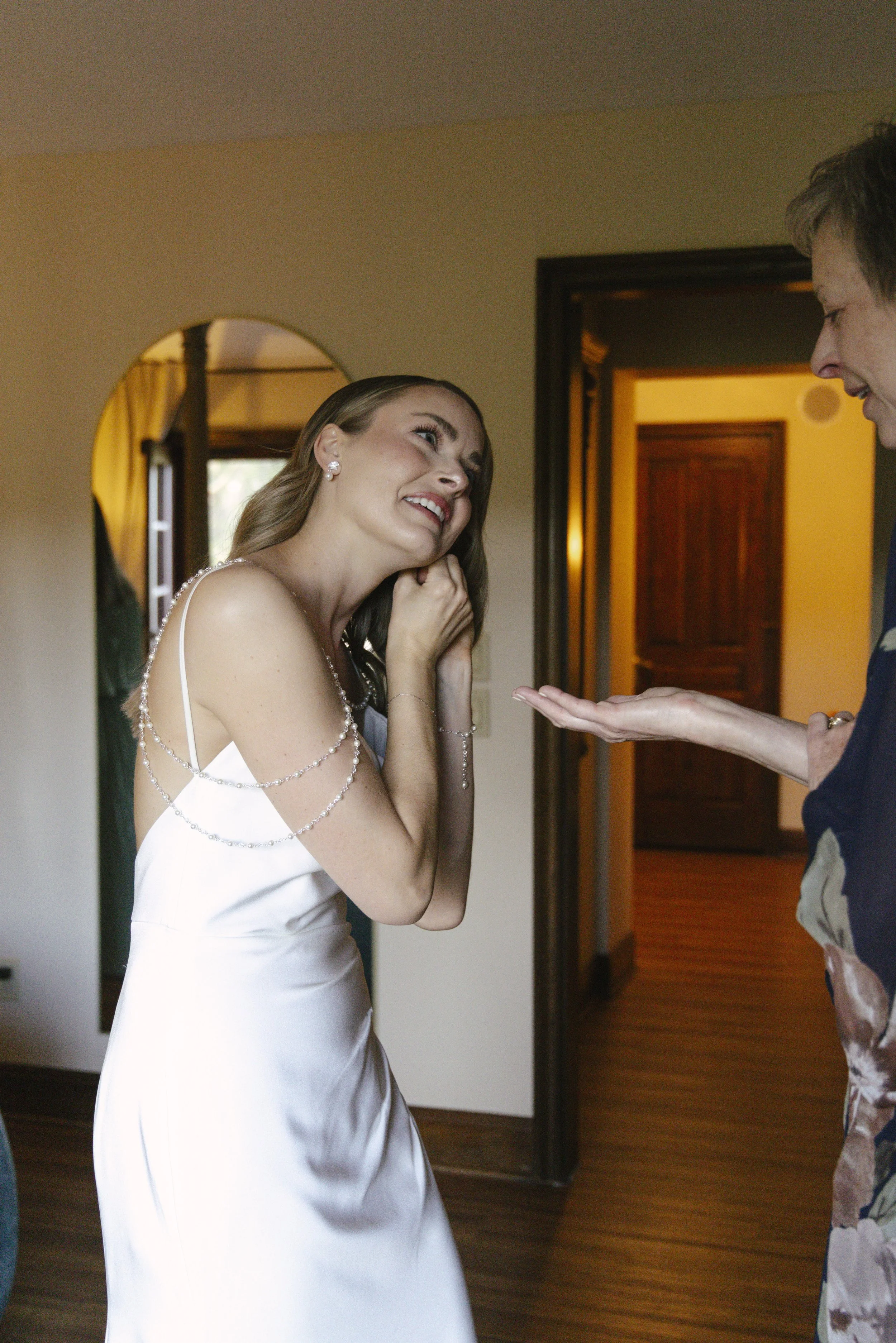 Chelsea and Travis' intimate Sedona elopement continued with heartfelt bridal getting-ready moments as the bride shared meaningful time with her mother and closest loved ones. From fastening her wedding dress and adding the finishing touches to quiet