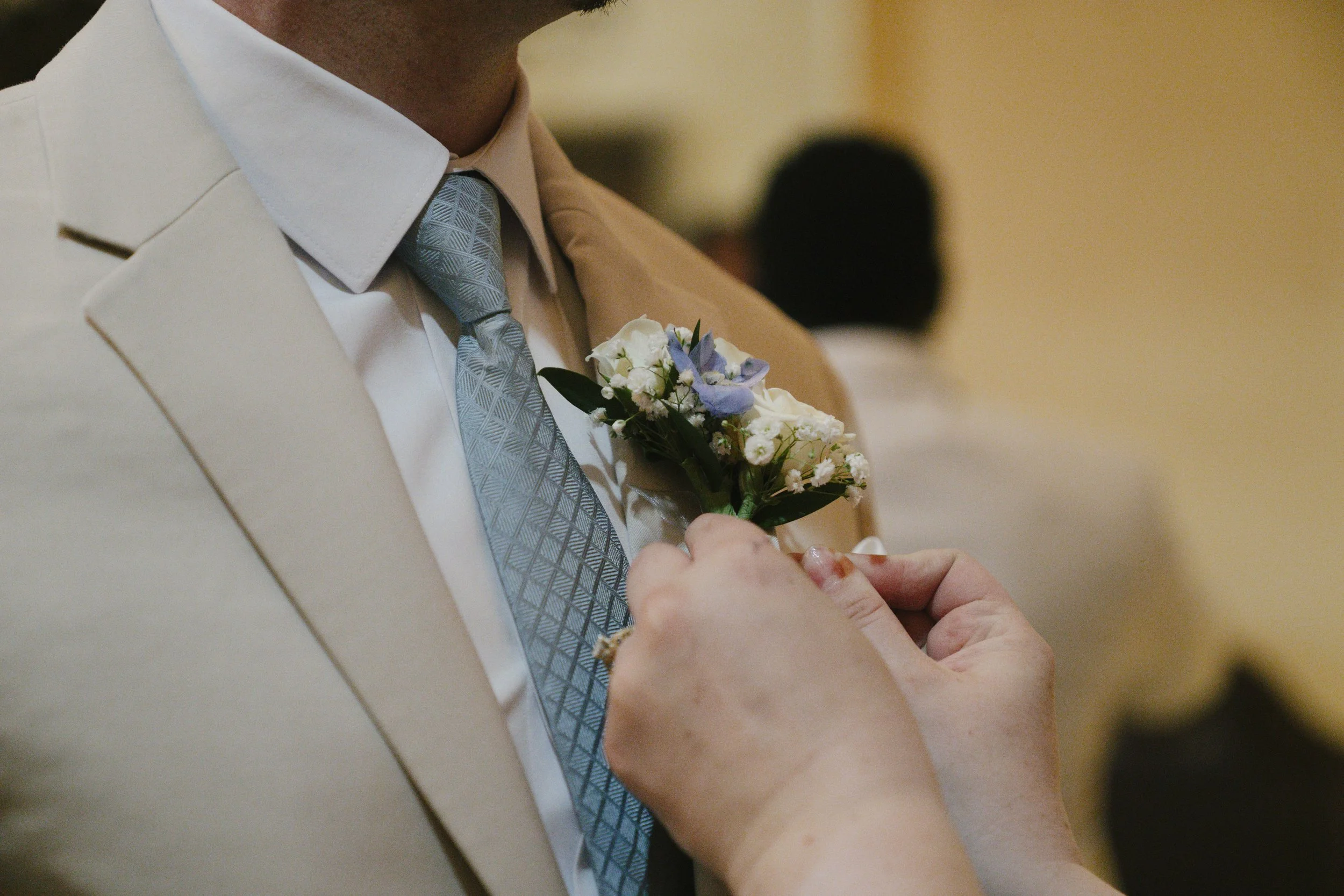 The groom’s getting-ready moments at Ashley Castle in Chandler, Arizona, capture the energy and anticipation of the wedding day, documented through hybrid film and digital photography to preserve both candid emotion and timeless detail inside this el