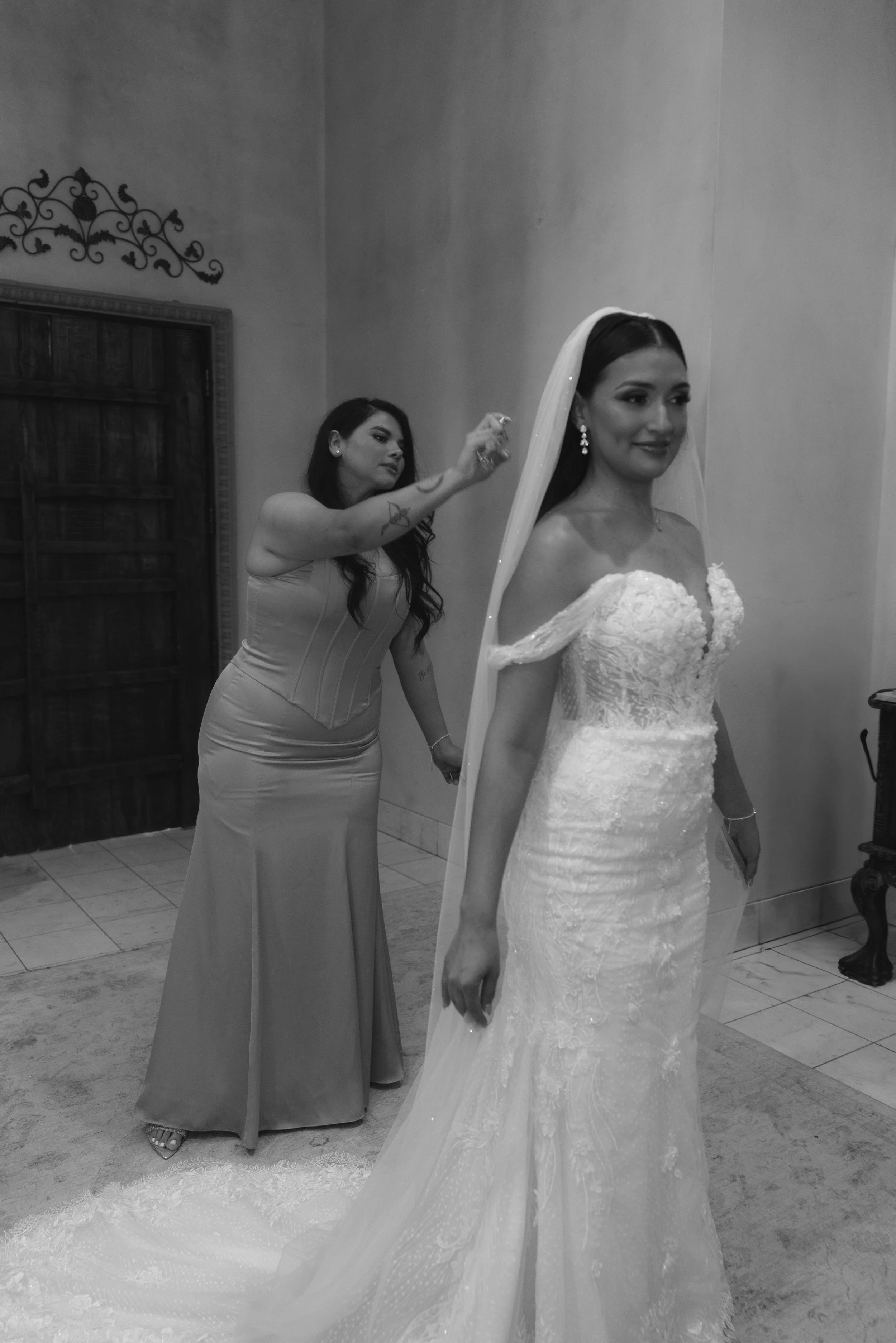 The bride’s final getting-ready moments at Ashley Castle in Chandler, Arizona, were captured through hybrid film and digital photography, preserving the intimate details of dress fastening, veil placement, and bridal finishing touches with timeless e