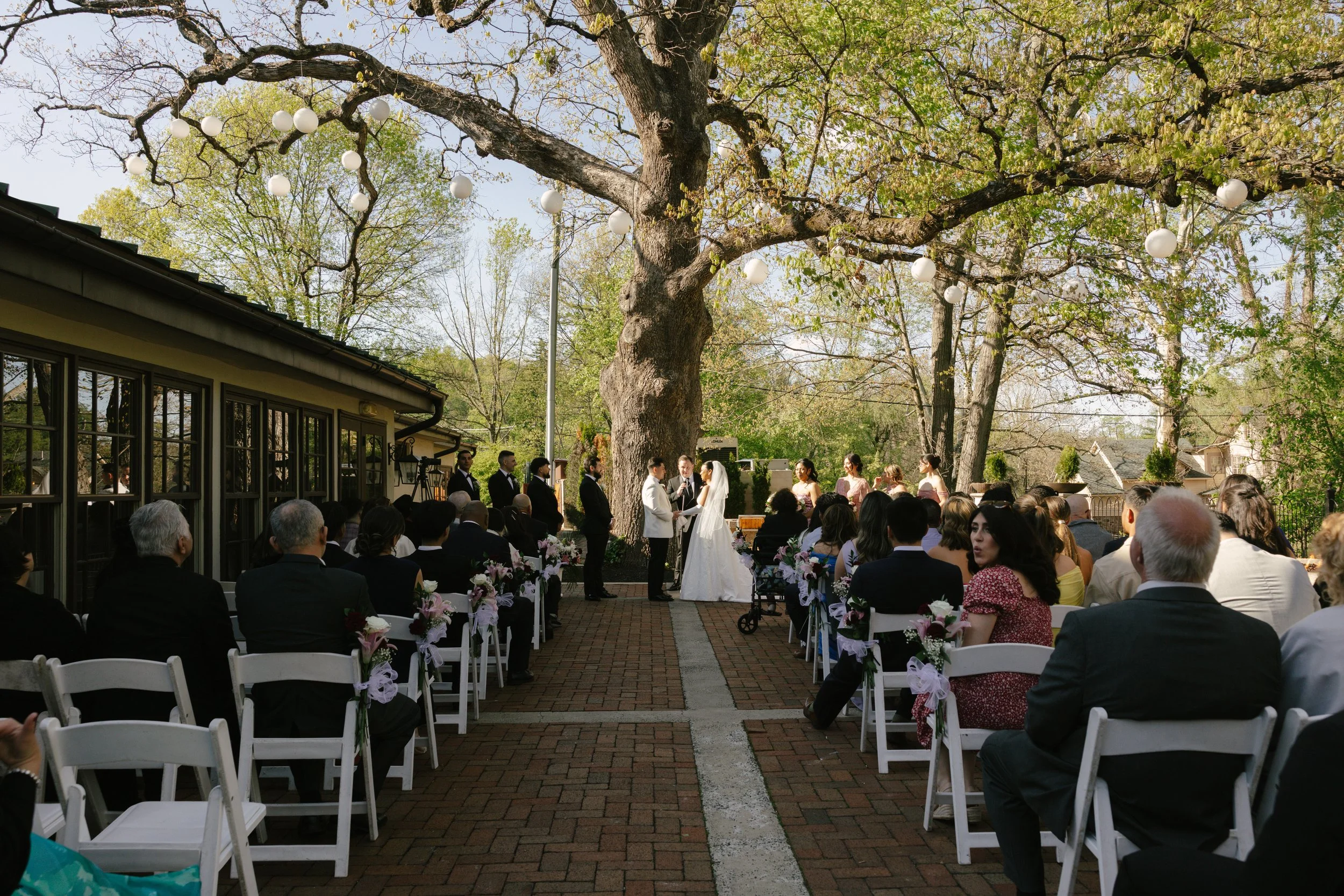 Outdoor wedding ceremony at Hotel DuVillage featuring the bride and groom, wedding party, and meaningful moments captured on both digital and 35mm film. A timeless celebration documented with a candid, documentary approach