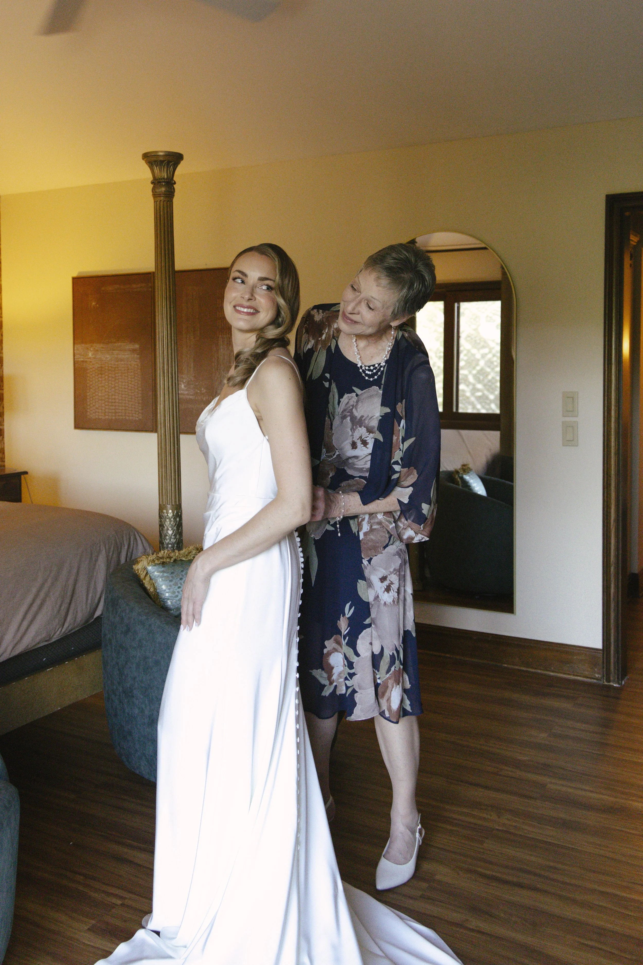Chelsea and Travis' intimate Sedona elopement continued with heartfelt bridal getting-ready moments as the bride shared meaningful time with her mother and closest loved ones. From fastening her wedding dress and adding the finishing touches to quiet
