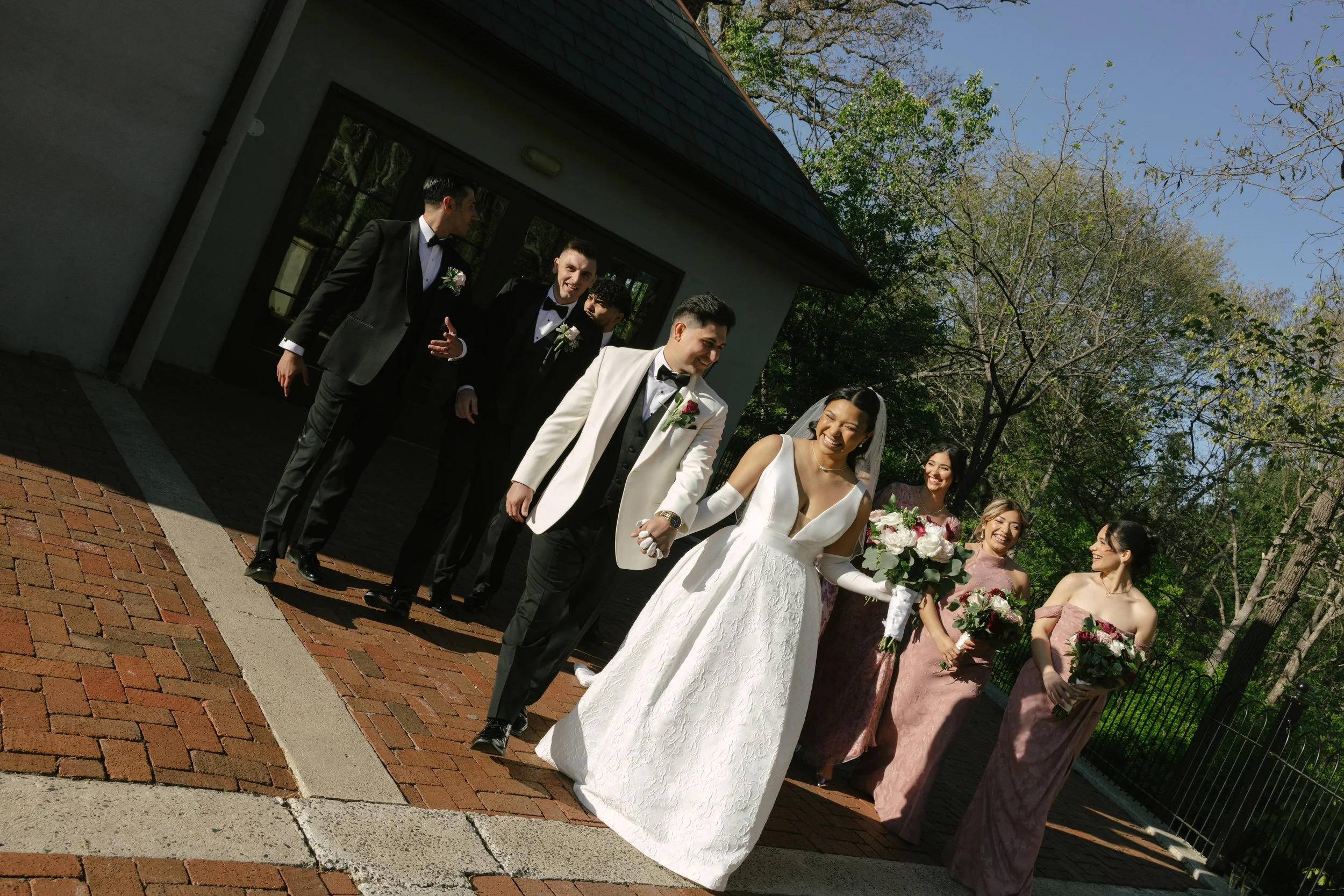 Bridal party portraits at Hotel DuVillage celebrate the bride and groom alongside their closest friends and family. Captured on digital and 35mm film, these images highlight genuine laughter, timeless portraits, and unforgettable moments.