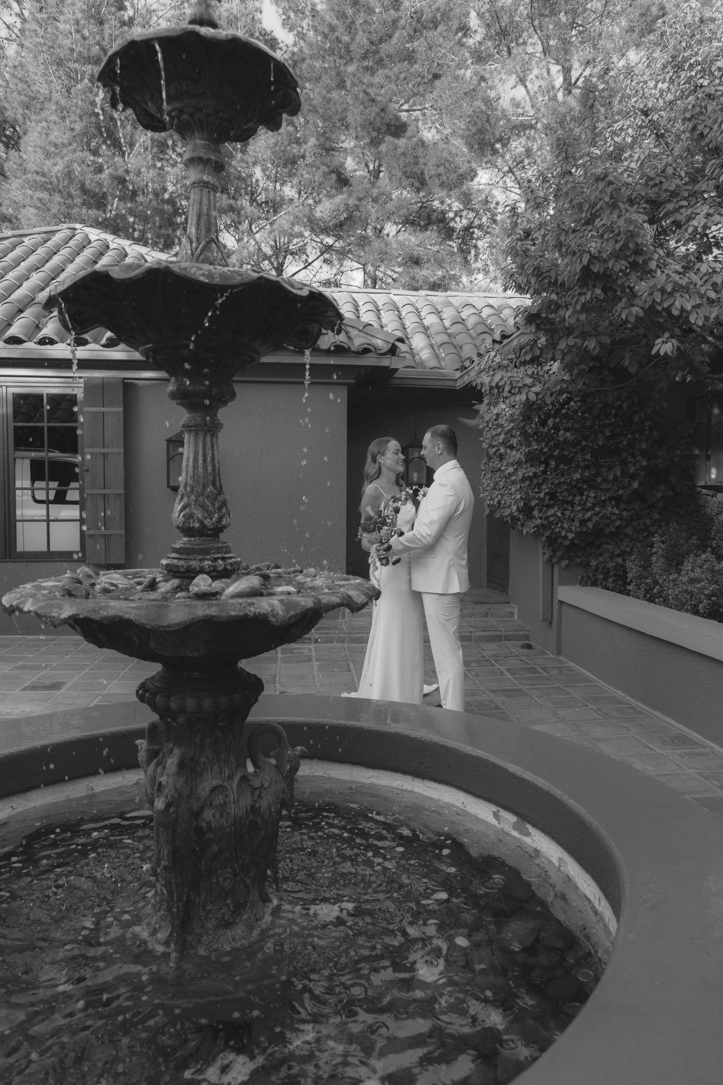 Romantic newlywed portraits from Chelsea and Travis' intimate Sedona, Arizona elopement, featuring elegant courtyard portraits, candid moments with their beloved dog, and timeless wedding photography captured after their private ceremony before golde