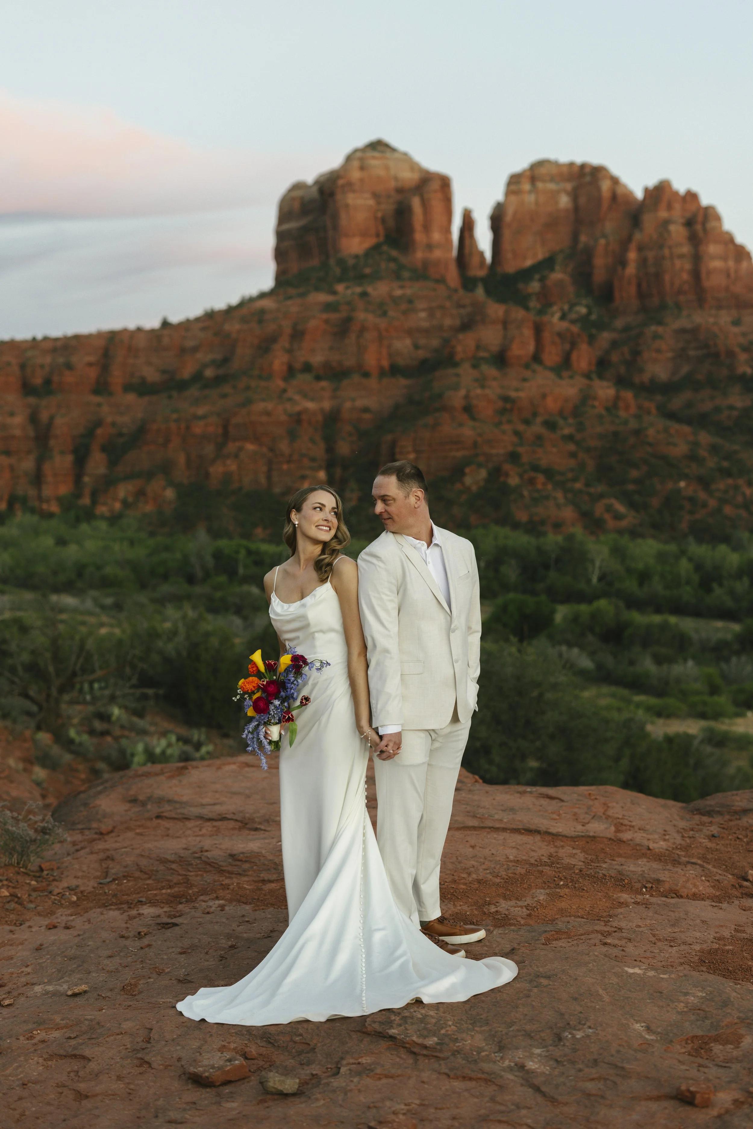 Romantic golden hour portraits at Secret Slick Rock during Chelsea and Travis' intimate Sedona elopement. Featuring Sedona's famous red rock views, stunning Arizona desert landscapes, and timeless wedding photography, these newlywed portraits perfect