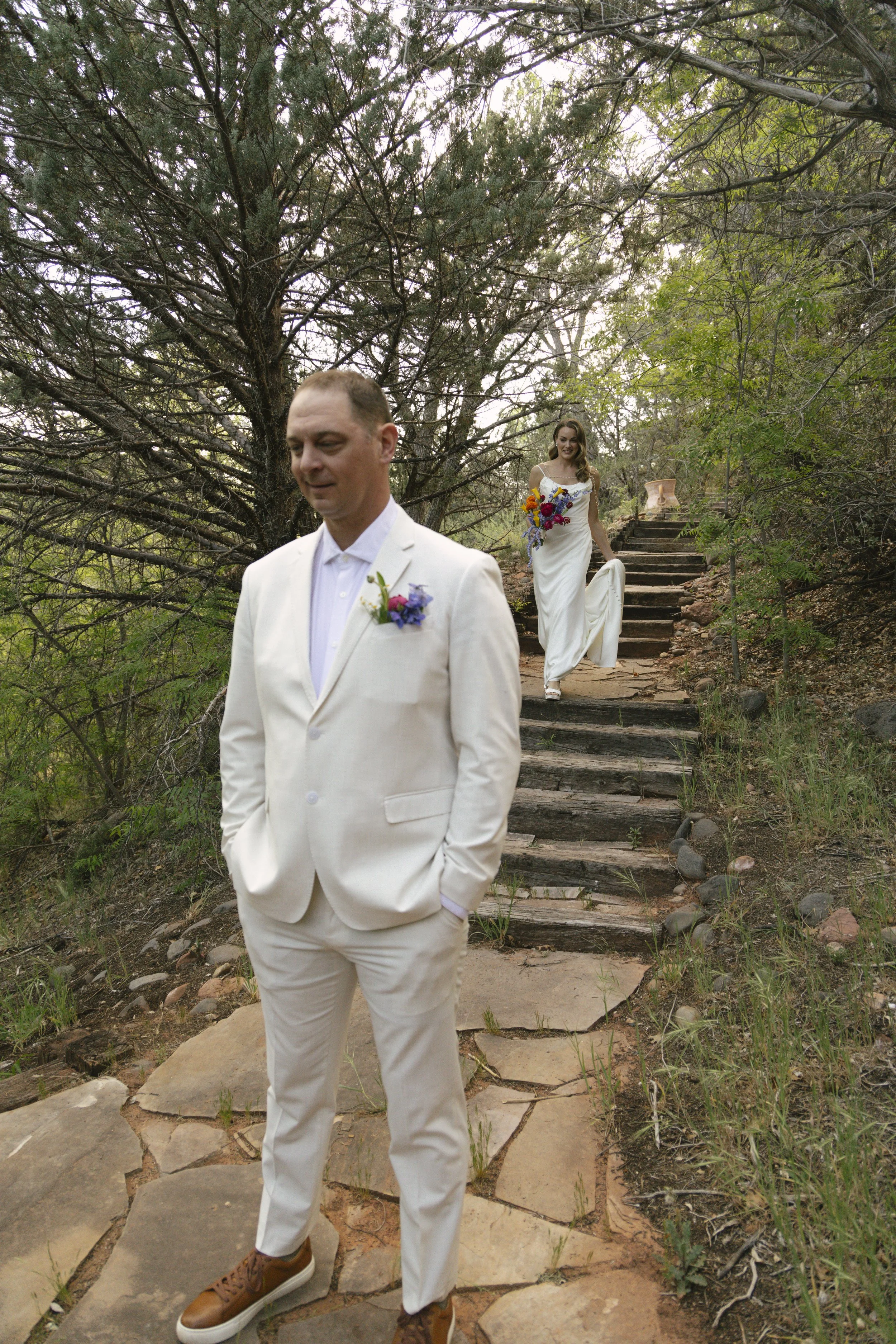 Chelsea and Travis shared an intimate first look surrounded by the natural beauty of Sedona before exchanging vows during their private Arizona elopement ceremony. Set along a peaceful garden path, these heartfelt moments marked the beginning of thei