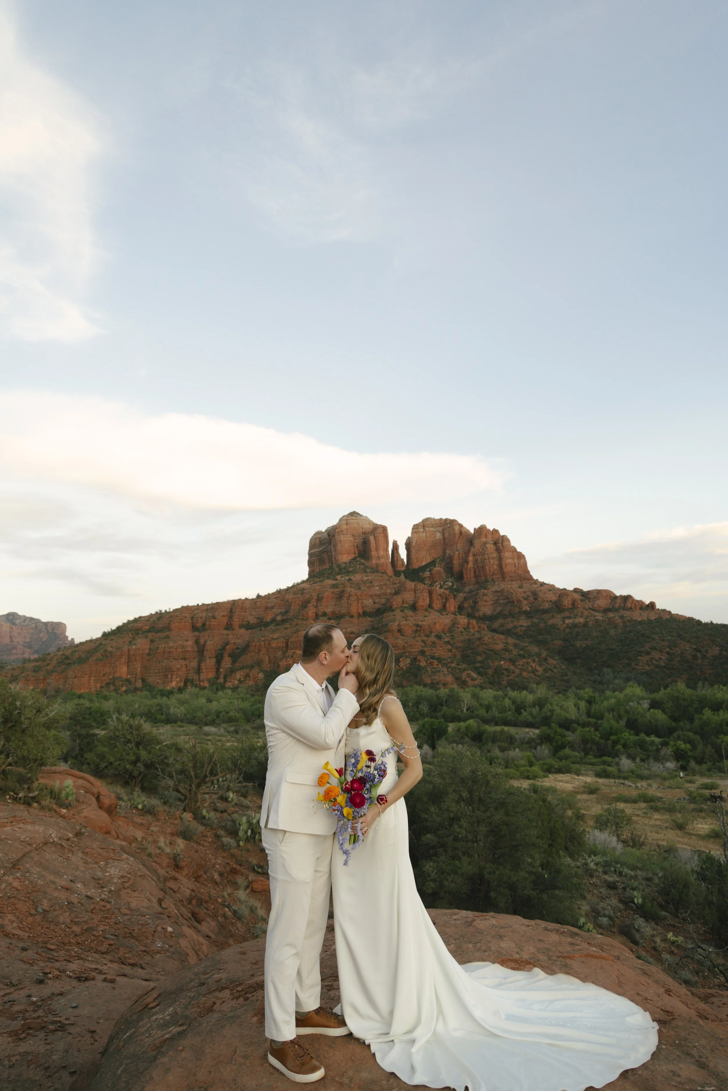 Romantic golden hour portraits at Secret Slick Rock during Chelsea and Travis' intimate Sedona elopement. Featuring Sedona's famous red rock views, stunning Arizona desert landscapes, and timeless wedding photography, these newlywed portraits perfect