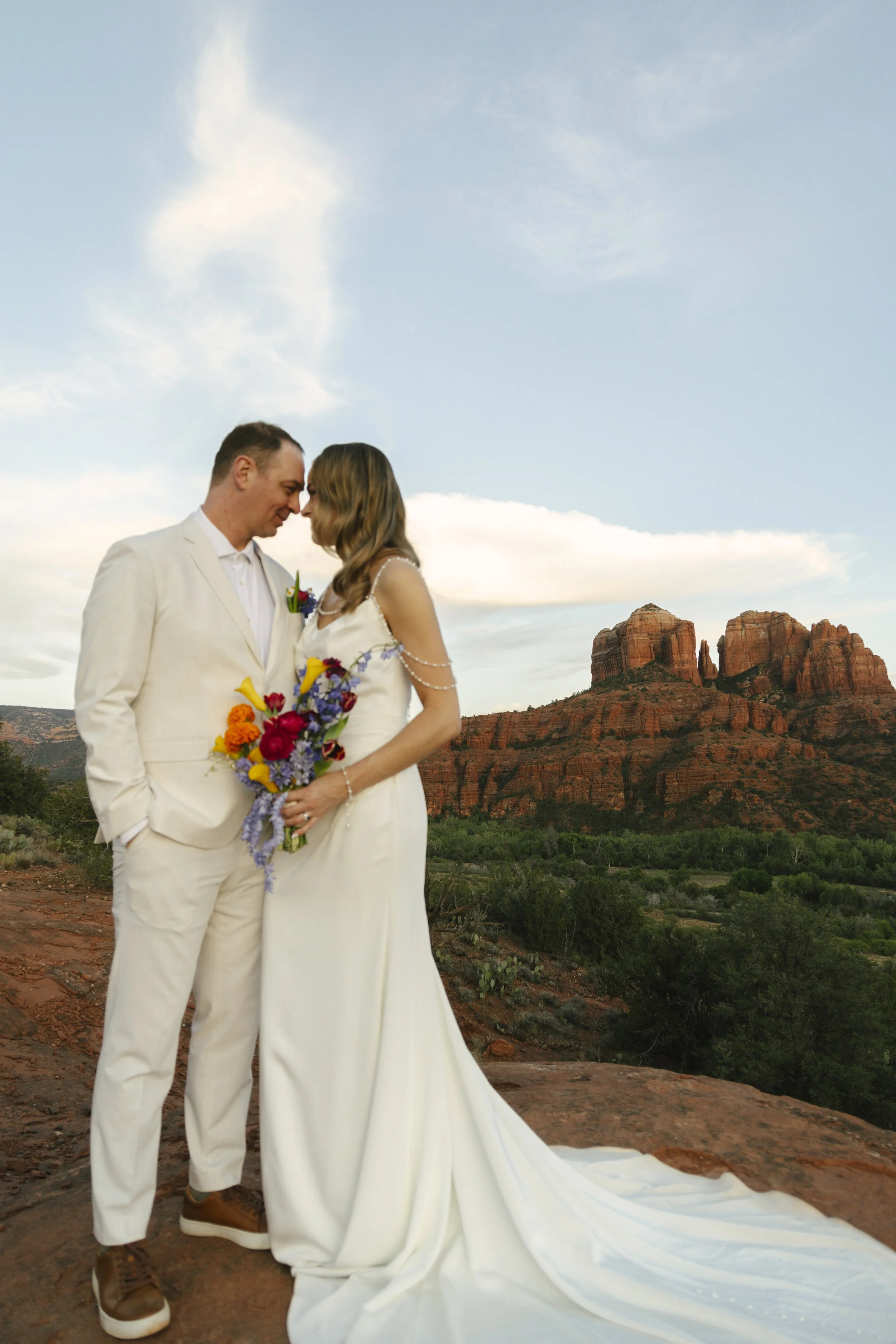 Romantic golden hour portraits at Secret Slick Rock during Chelsea and Travis' intimate Sedona elopement. Featuring Sedona's famous red rock views, stunning Arizona desert landscapes, and timeless wedding photography, these newlywed portraits perfect
