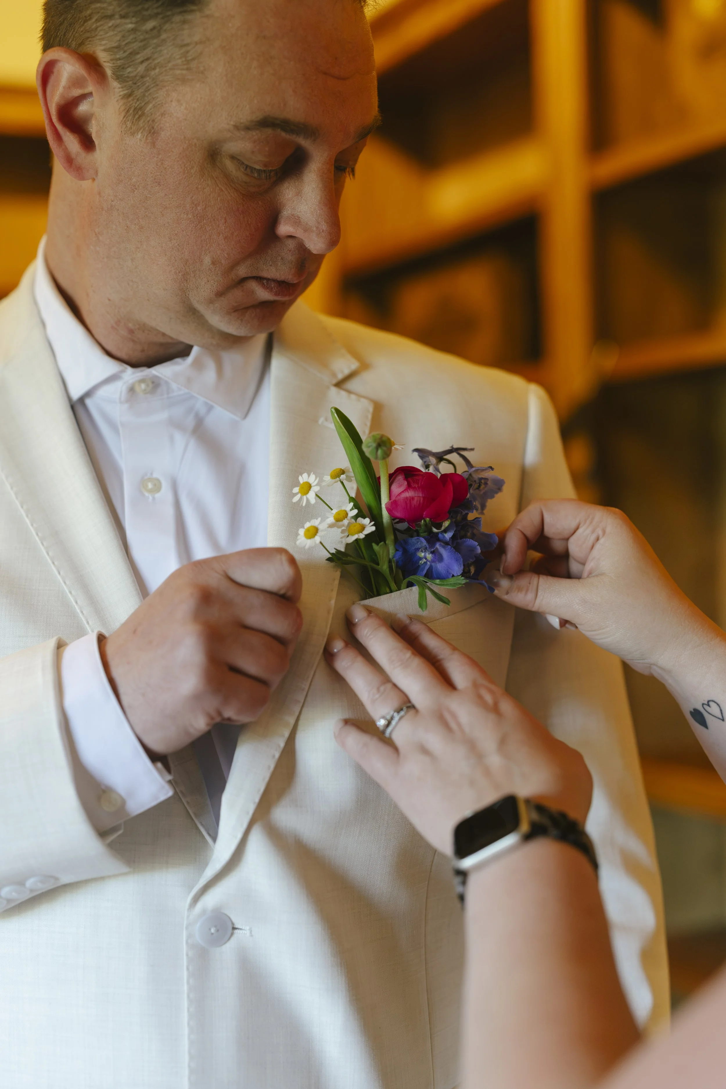Chelsea and Travis' intimate Sedona elopement began with the groom getting ready alongside his family at a private Arizona home. From tailored wedding attire and meaningful family portraits to heartfelt moments helping him prepare, every detail refle