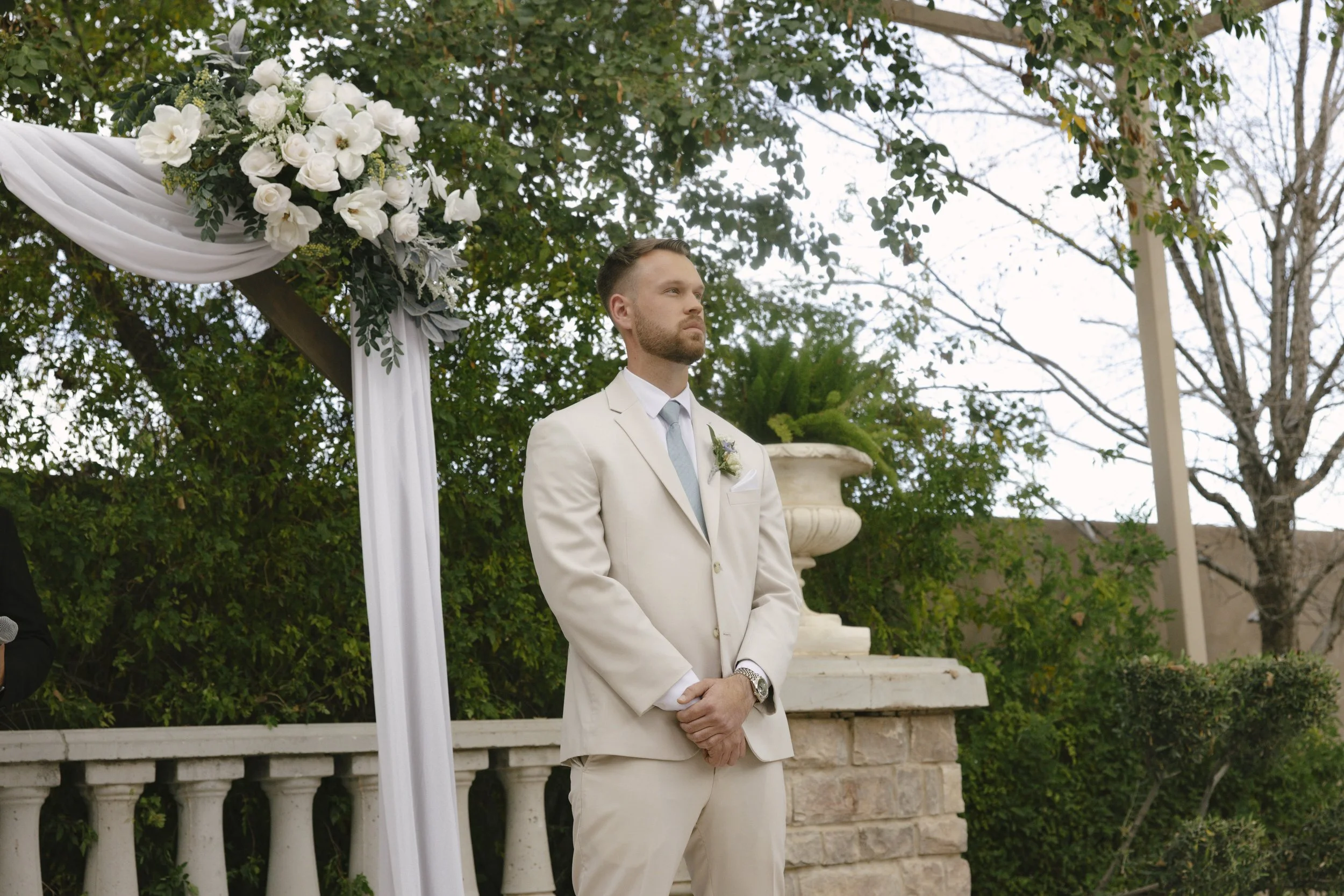 The wedding processional at Ashley Castle in Chandler, Arizona, was captured through hybrid film and digital photography, preserving the graceful entrances of the bridal party as they made their way through the romantic outdoor ceremony space surroun