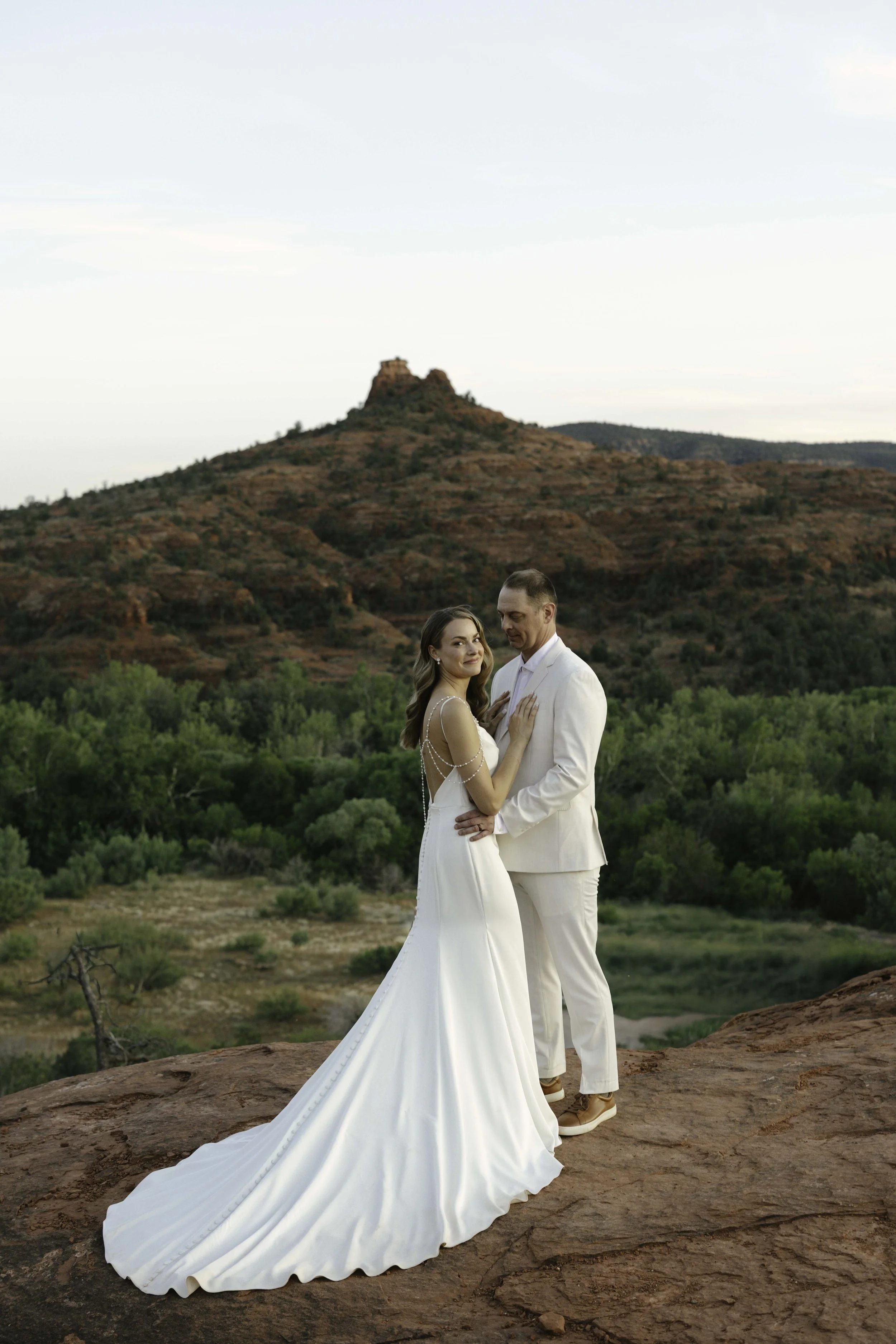 Romantic golden hour portraits at Secret Slick Rock during Chelsea and Travis' intimate Sedona elopement. Featuring Sedona's famous red rock views, stunning Arizona desert landscapes, and timeless wedding photography, these newlywed portraits perfect