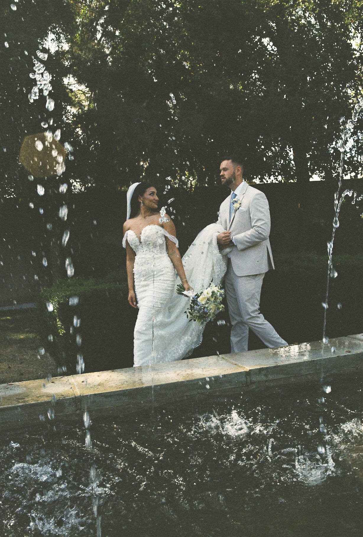 Romantic bride and groom portraits at Ashley Castle in Chandler, Arizona, captured through hybrid film and digital photography, showcase intimate newlywed moments filled with emotion, elegant garden backdrops, and timeless wedding-day connection.