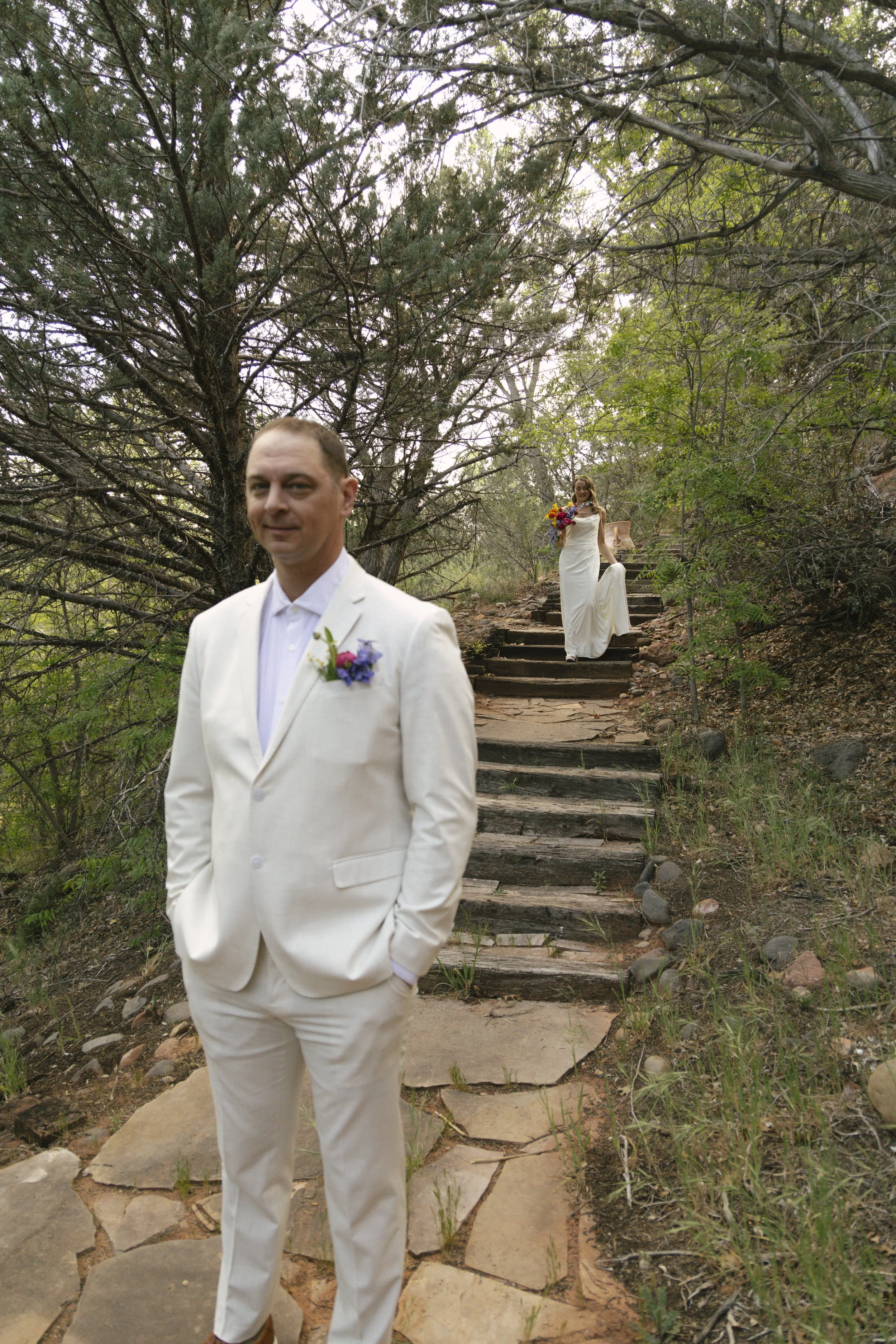Chelsea and Travis shared an intimate first look surrounded by the natural beauty of Sedona before exchanging vows during their private Arizona elopement ceremony. Set along a peaceful garden path, these heartfelt moments marked the beginning of thei
