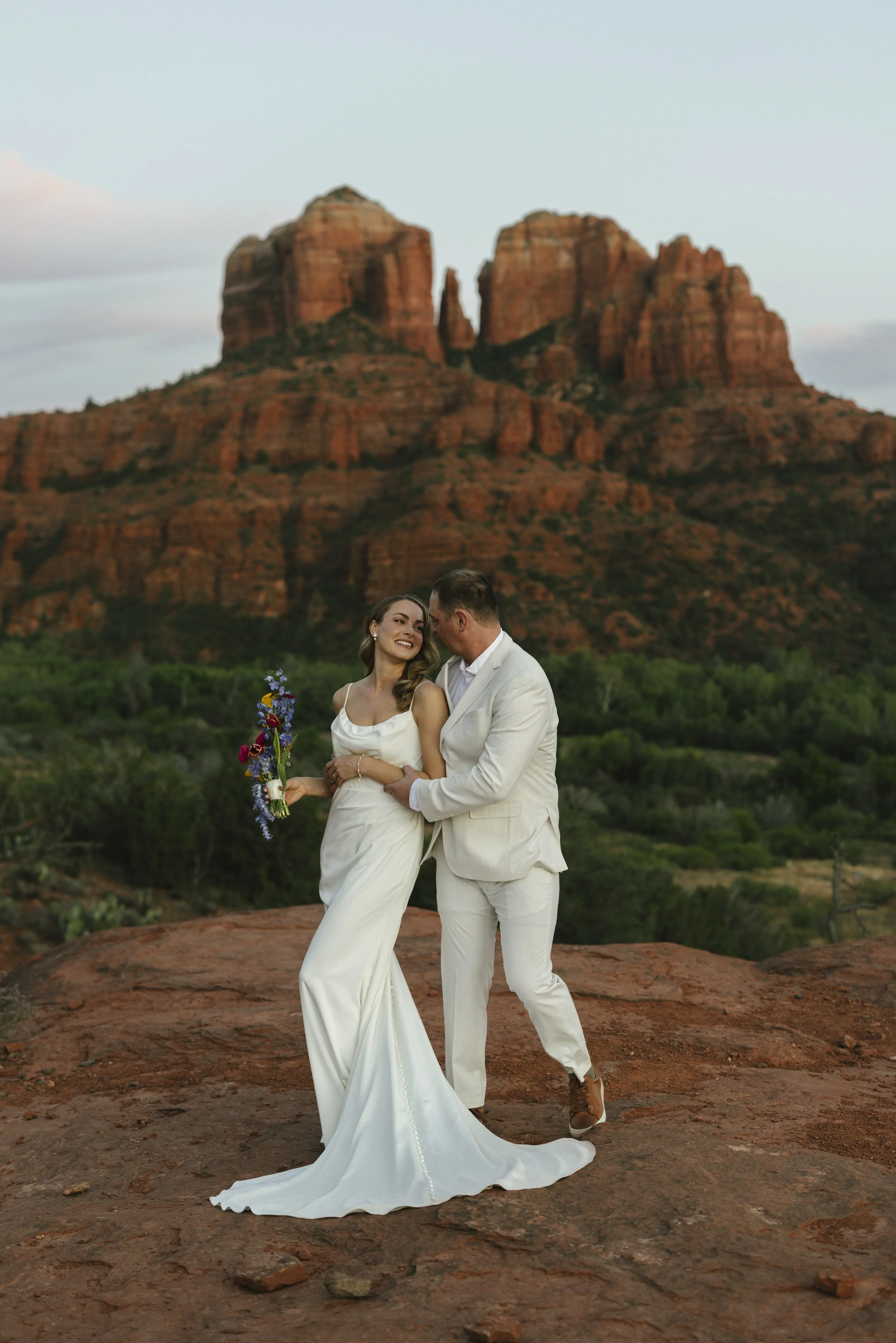 Romantic golden hour portraits at Secret Slick Rock during Chelsea and Travis' intimate Sedona elopement. Featuring Sedona's famous red rock views, stunning Arizona desert landscapes, and timeless wedding photography, these newlywed portraits perfect