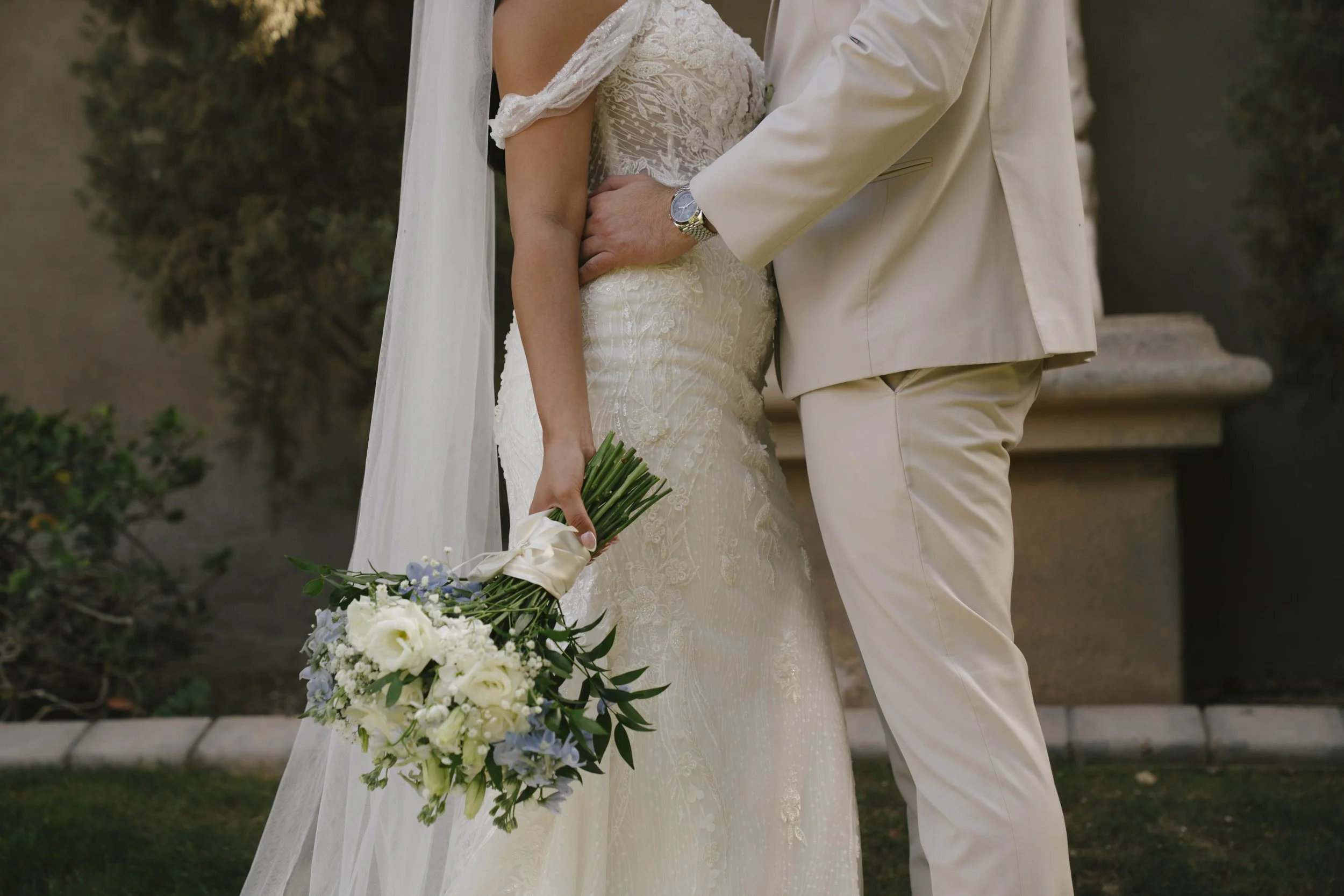 Romantic bride and groom portraits at Ashley Castle in Chandler, Arizona, captured through hybrid film and digital photography, showcase intimate newlywed moments filled with emotion, elegant garden backdrops, and timeless wedding-day connection.