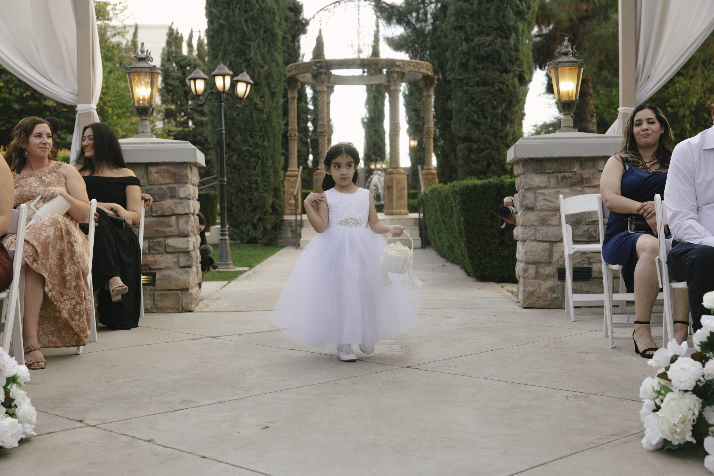 The wedding processional at Ashley Castle in Chandler, Arizona, was captured through hybrid film and digital photography, preserving the graceful entrances of the bridal party as they made their way through the romantic outdoor ceremony space surroun